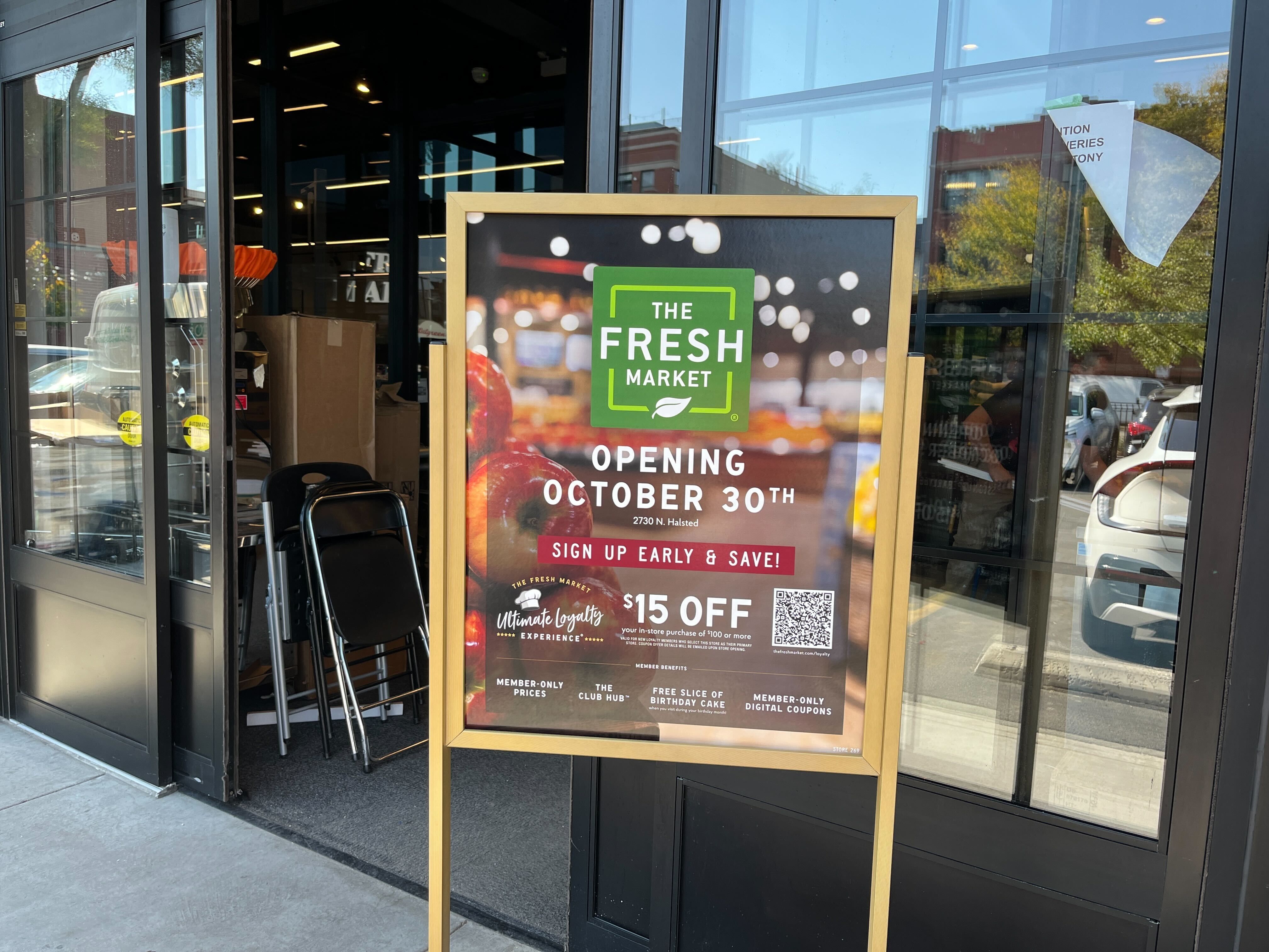 sandwich board sign in front of a grocery store