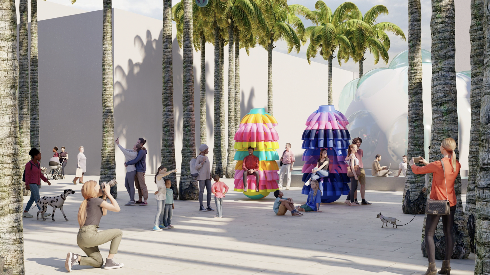 Colorful umbrella-type installations line a street beneath palm trees. 