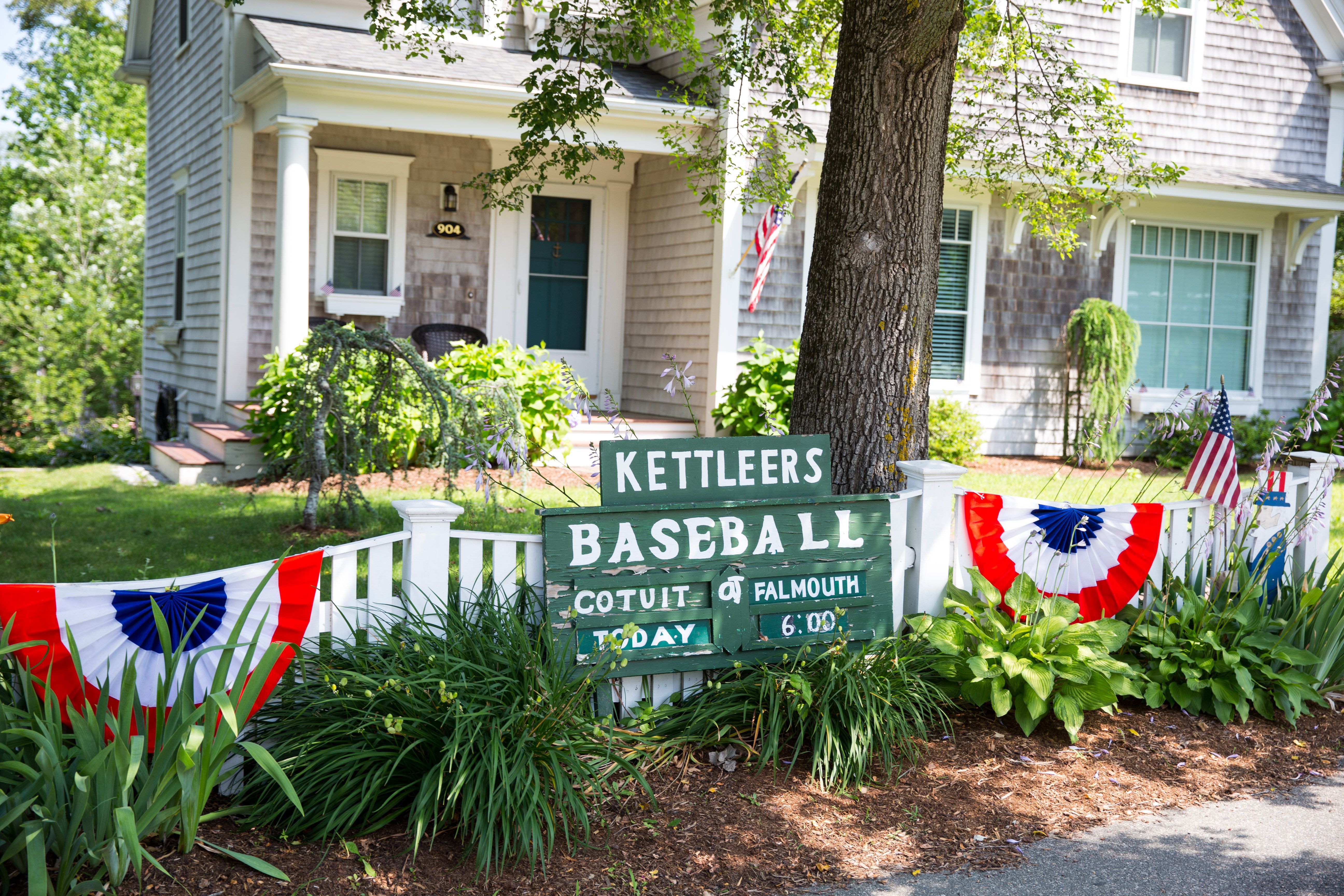 A baseball sign in front of a house.