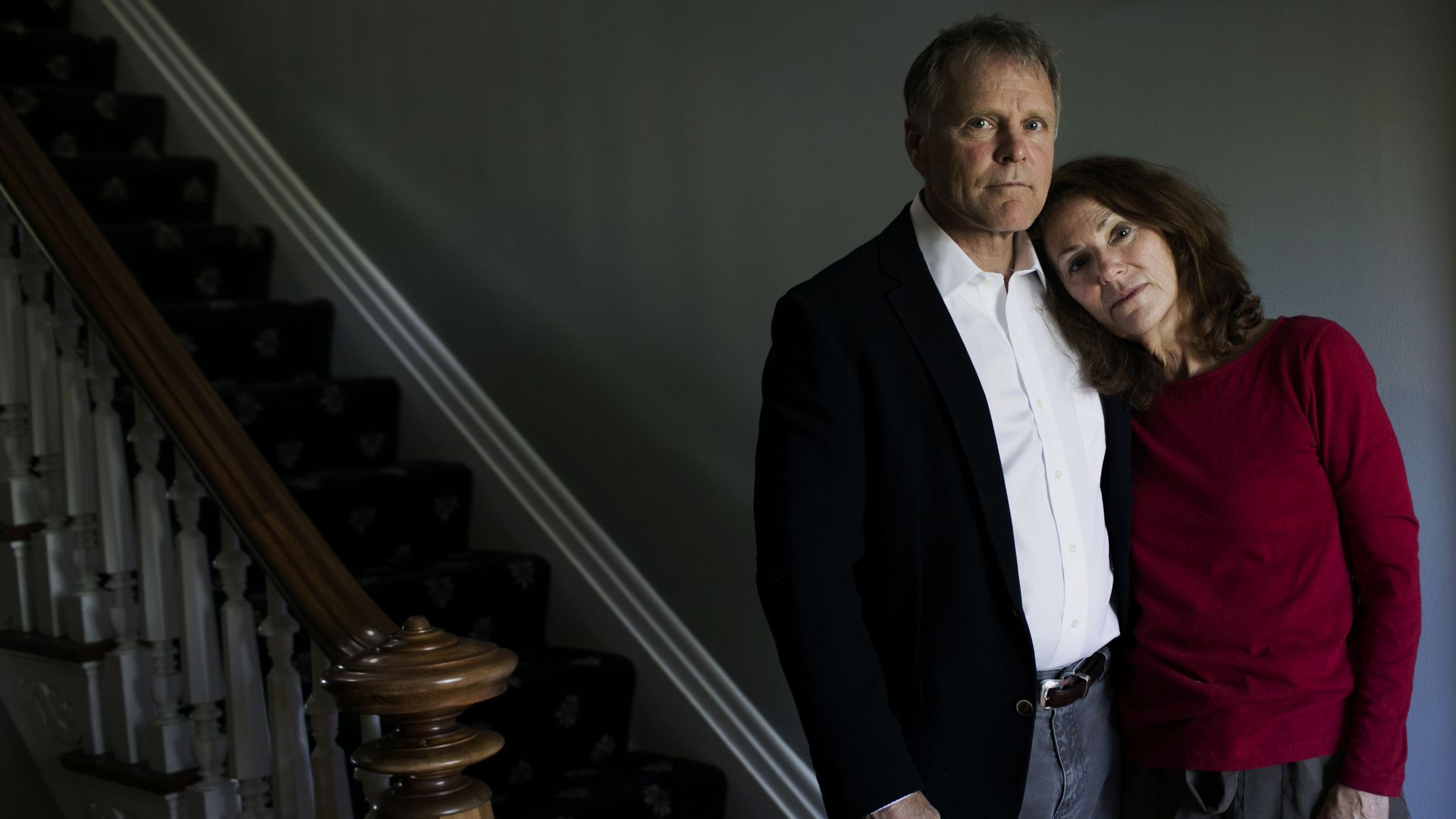 Fred and Cindy Warmbier by a staircase in their home.