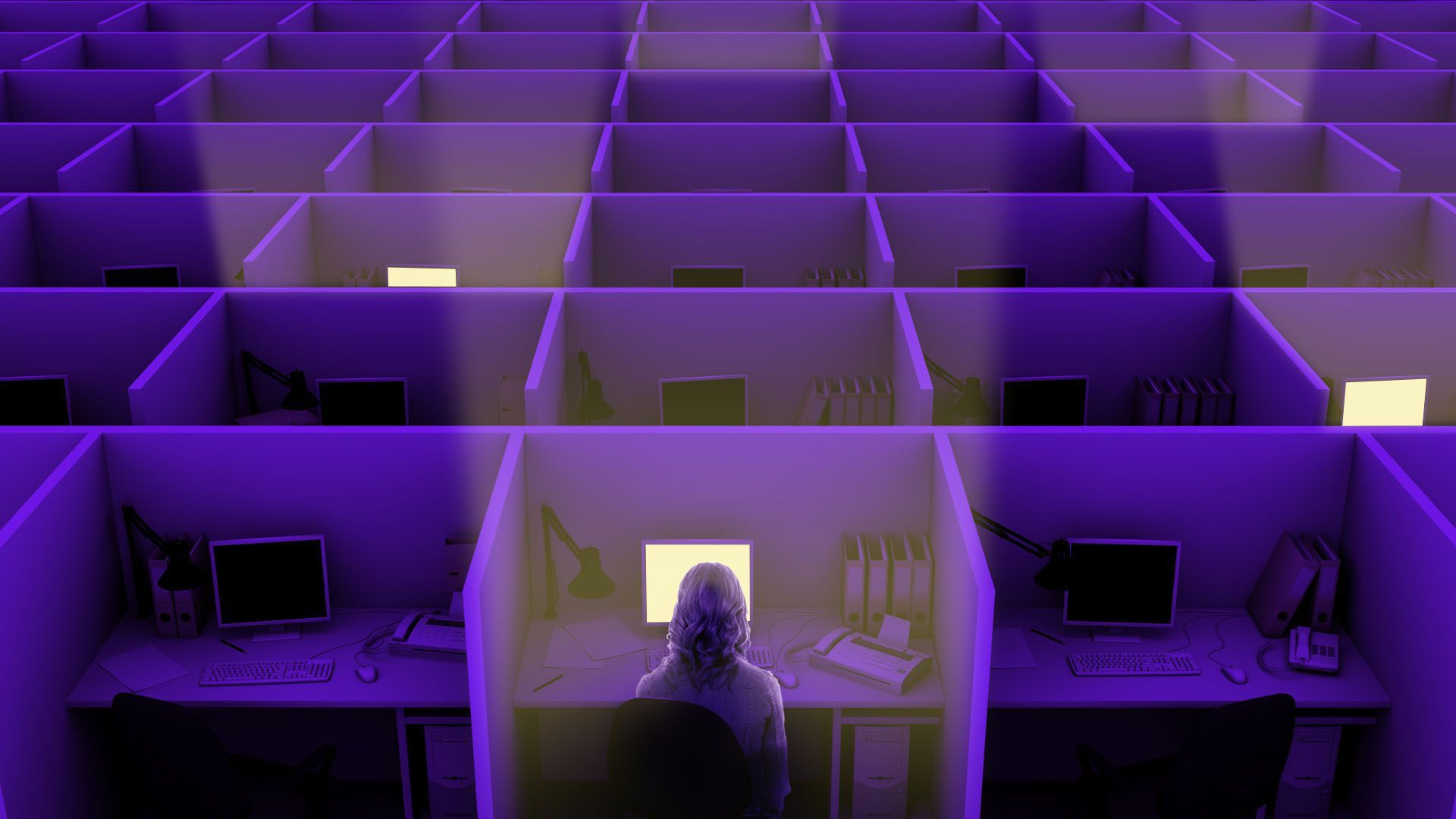 An illustration of a woman sitting at a computer a cubicle working at night