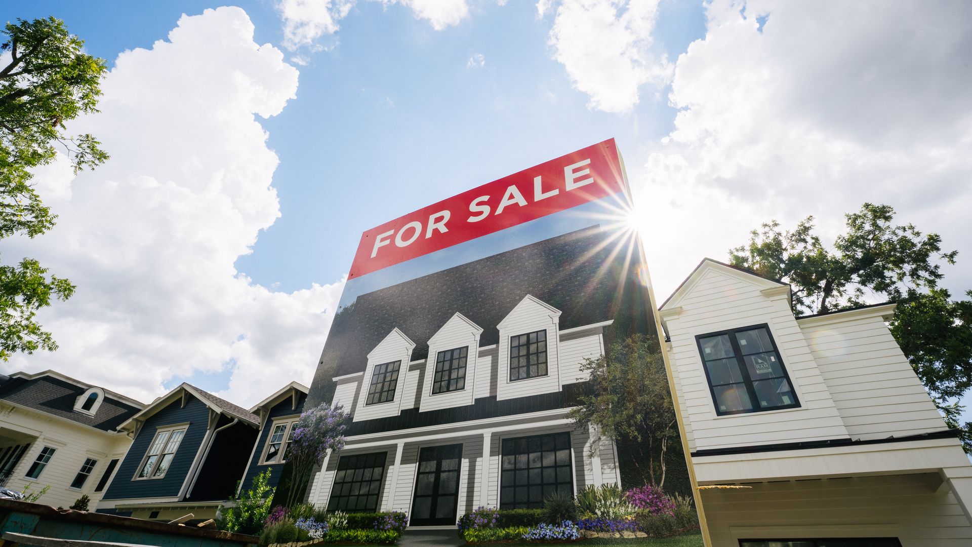 A "for sale" sign in front of a Houston home