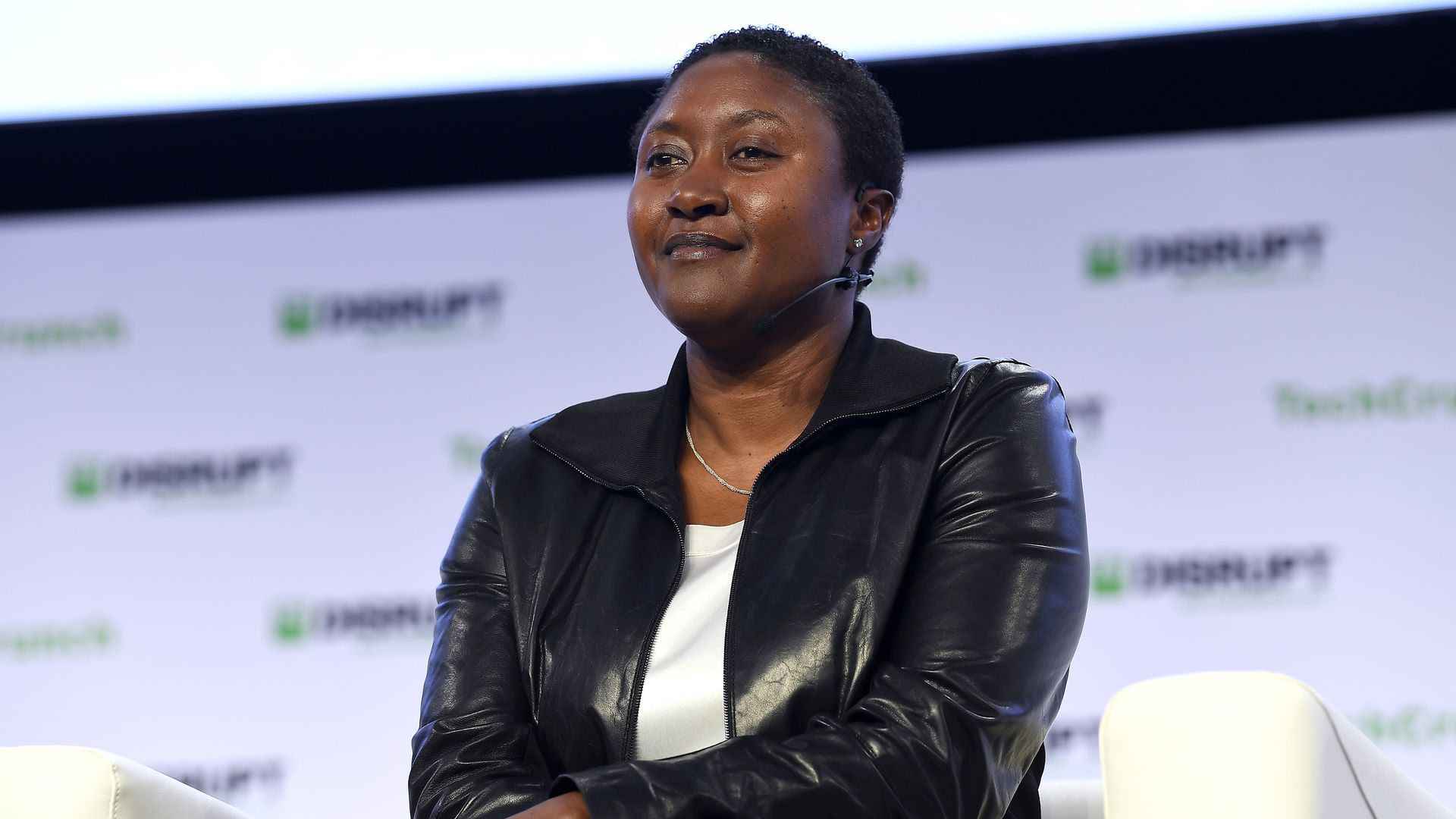 The Zoox CEO smiling and crossing her arms.