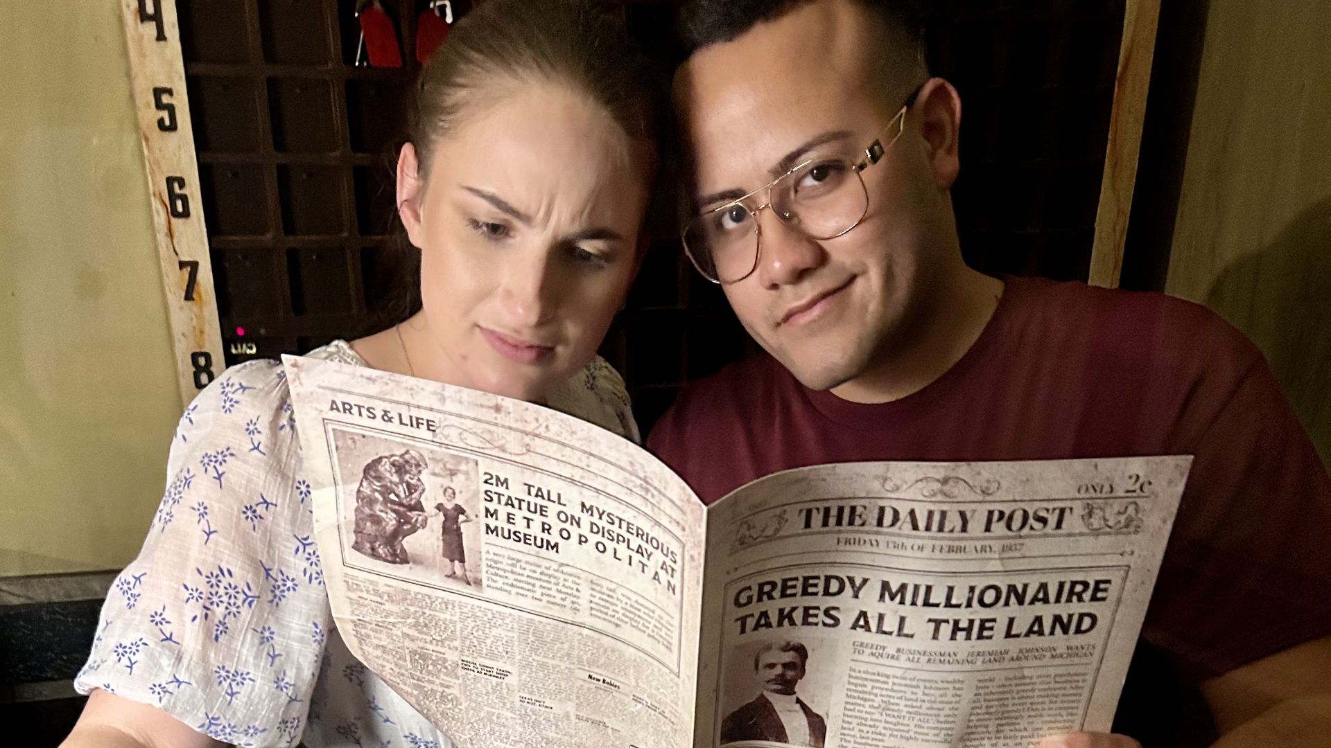 Yacob and his girlfriend, Maya, reading a fictional newspaper at Game Over Clearwater.