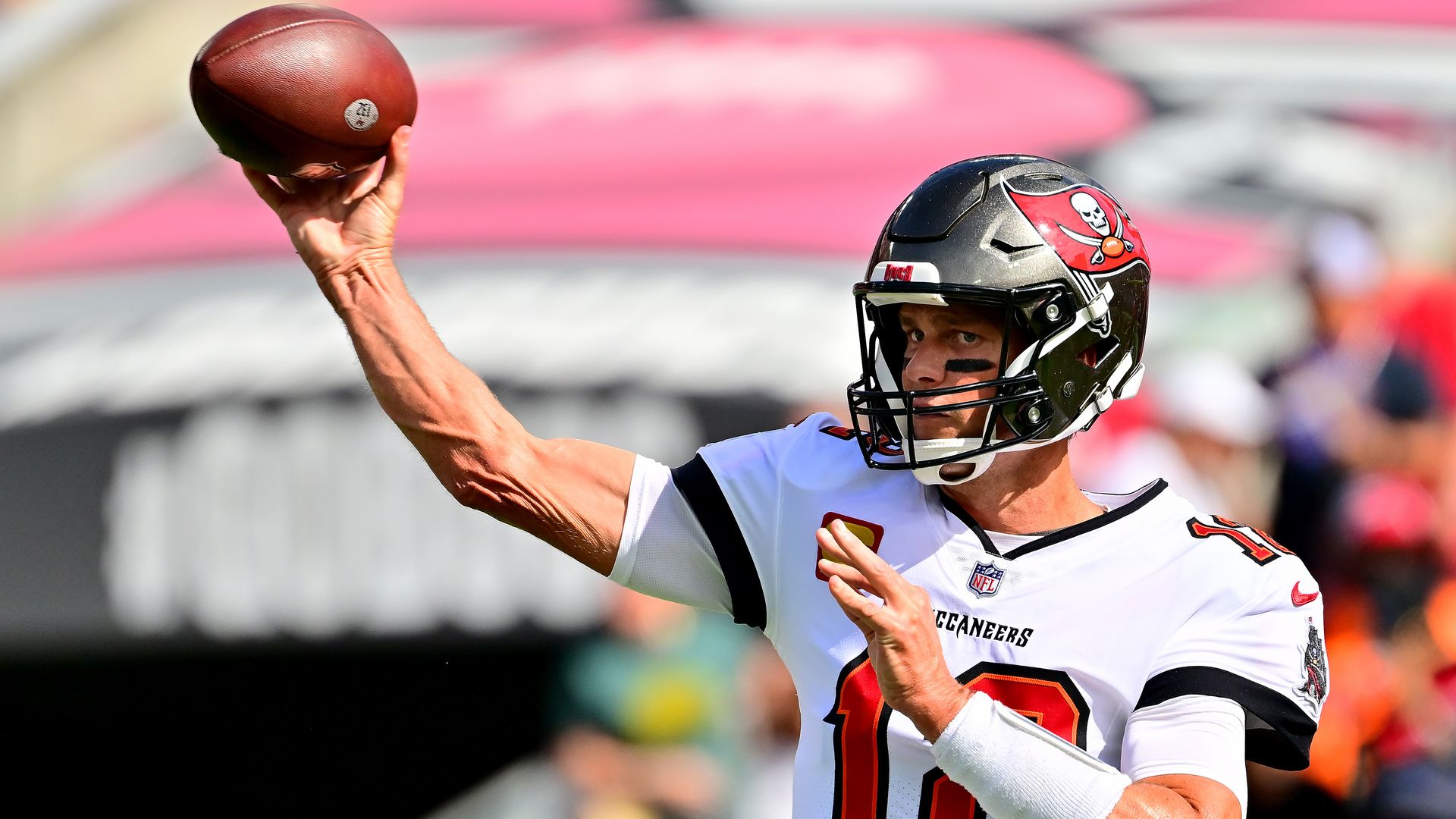 Tom Brady throws a football during practice.