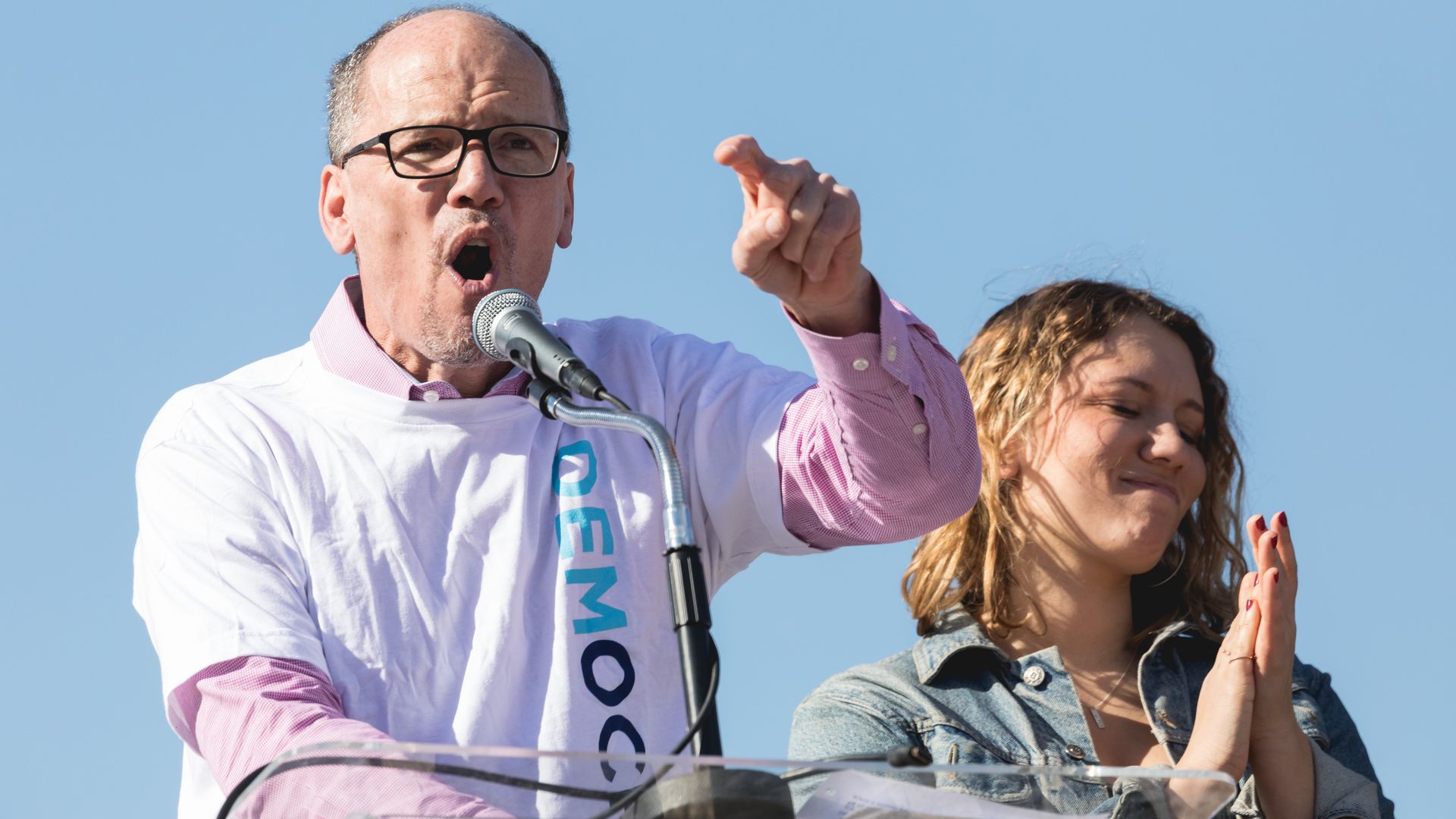 Tom Perez, chairman of the DNC, standing a podium yelling and pointing