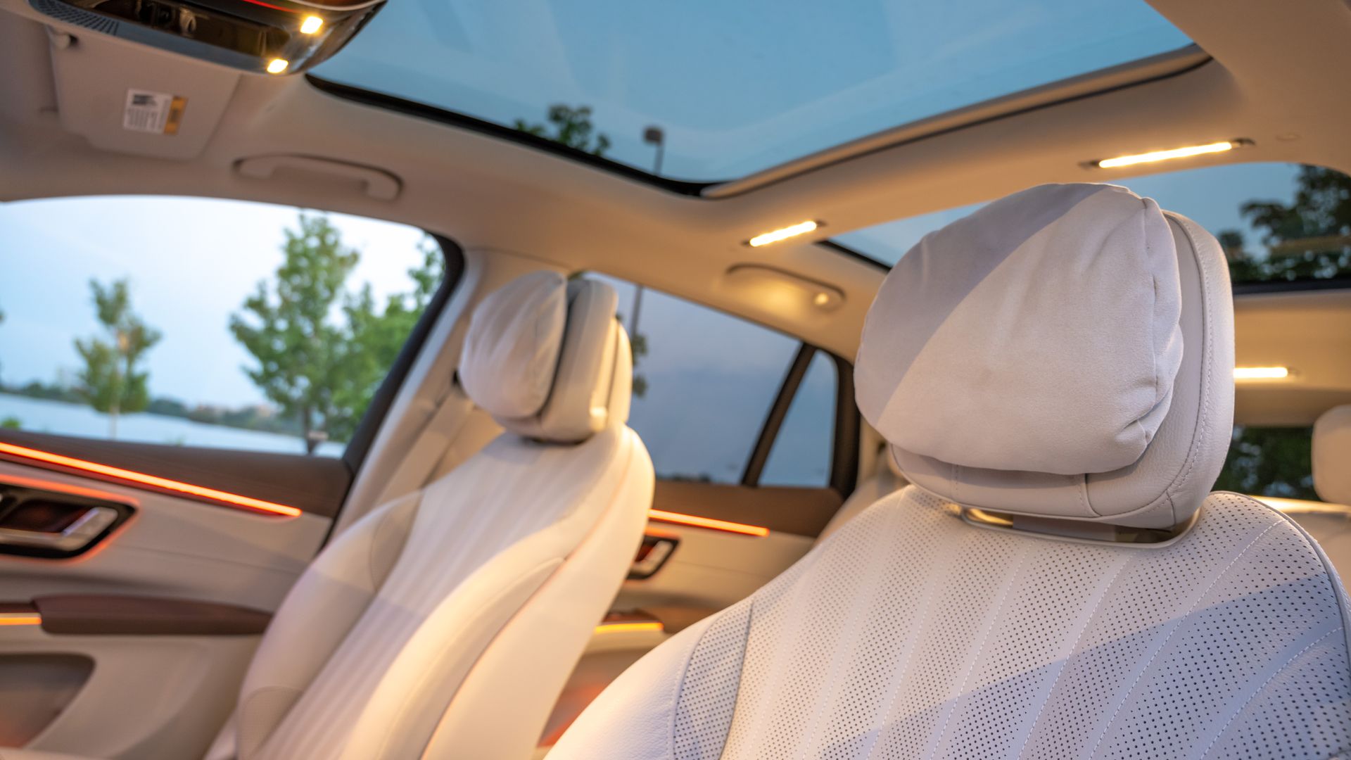 Images showing fluffy pillows attached to the headrests of the Mercedes EQS SUV