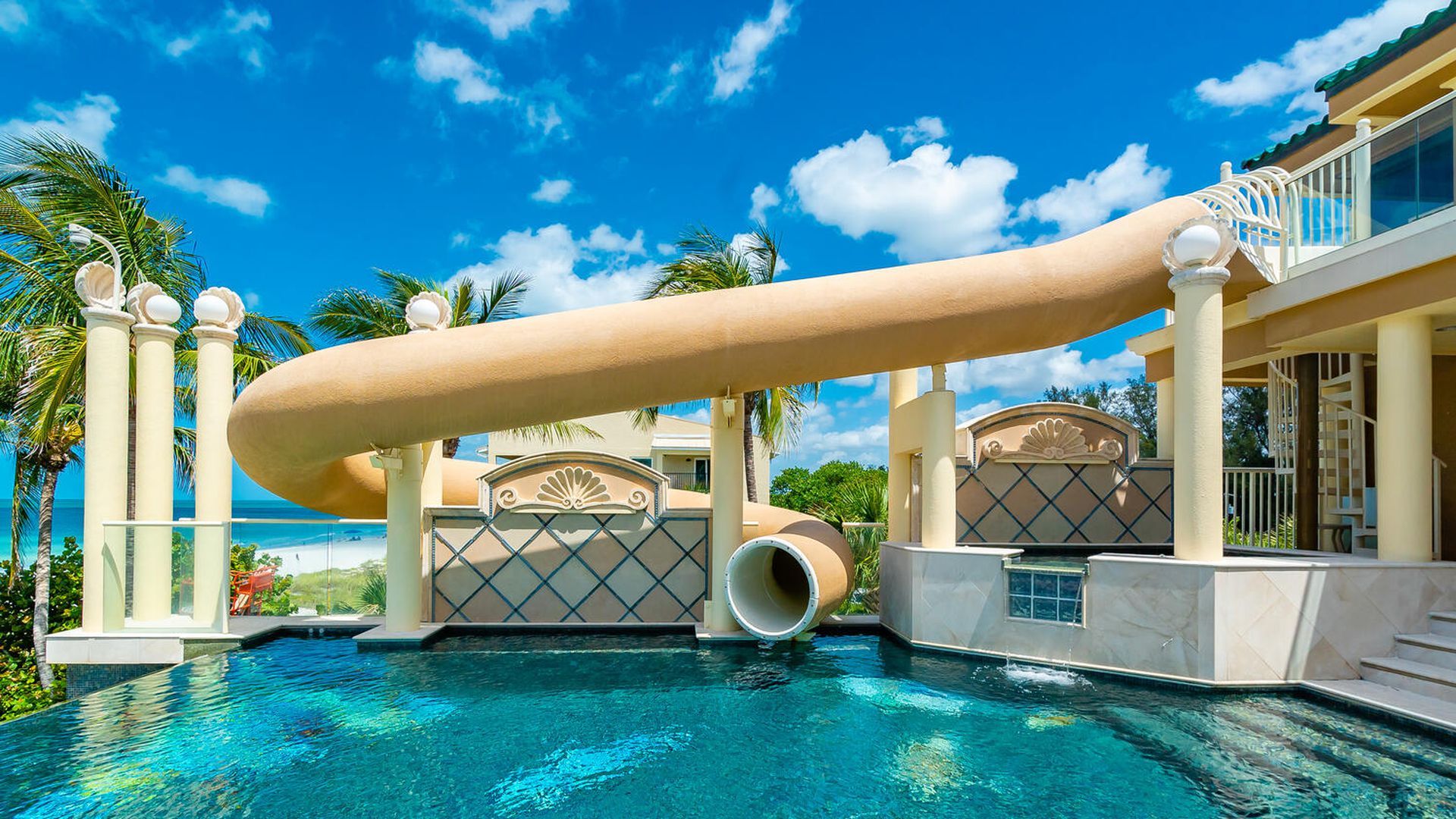 A waterslide at a waterfront mansion