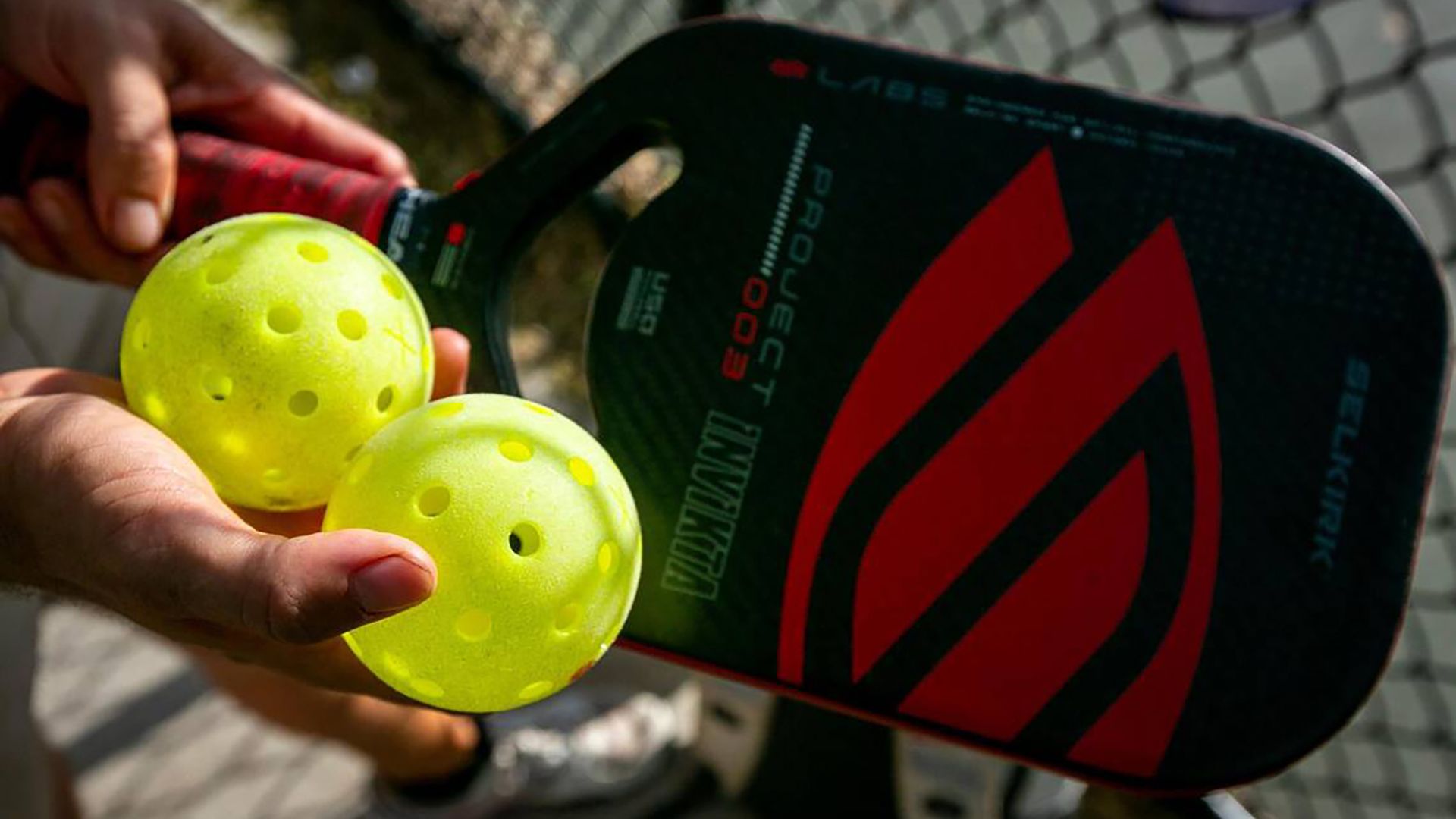 A pickleball paddle and balls