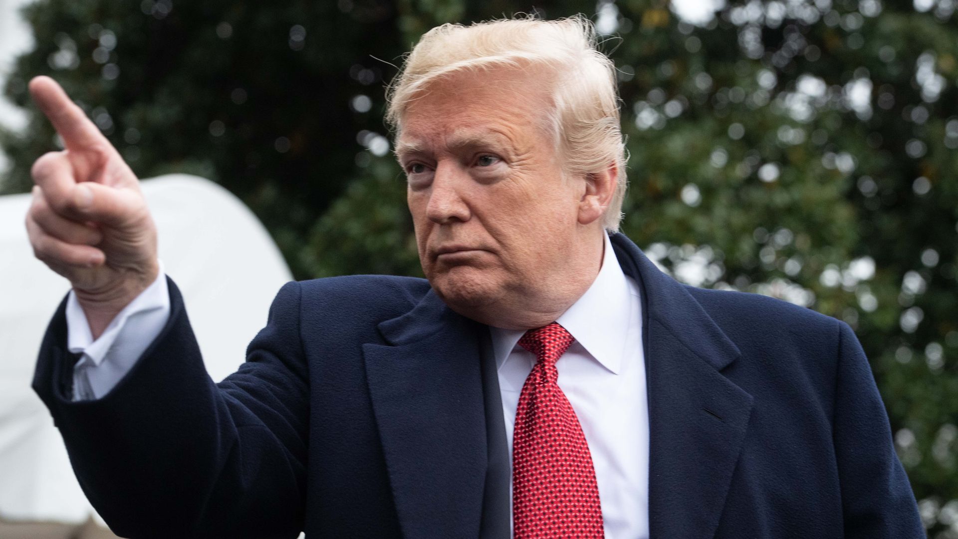 Donald Trump pointing a finger dramatically at reporters. 