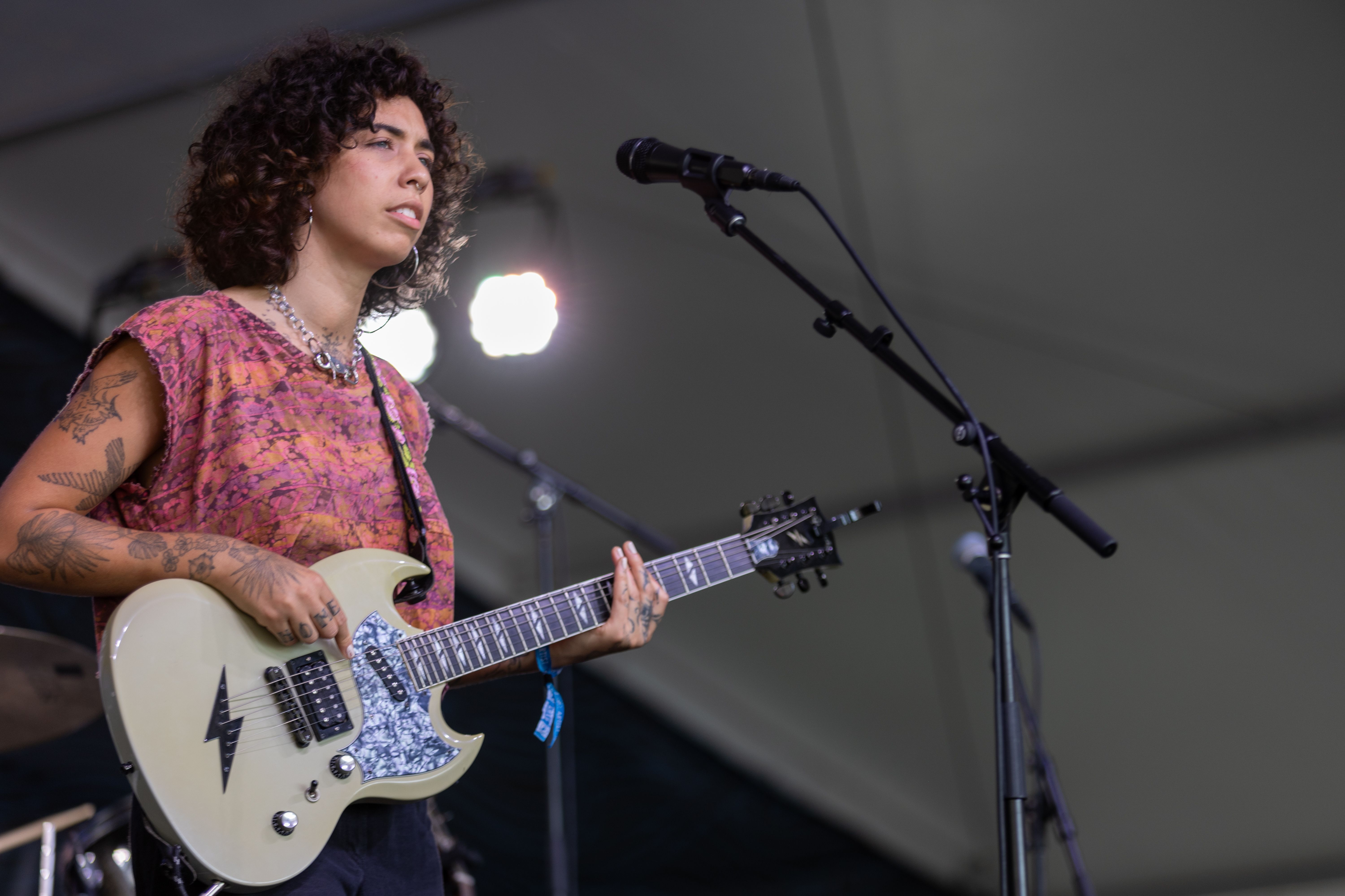 woman on stage with guitar