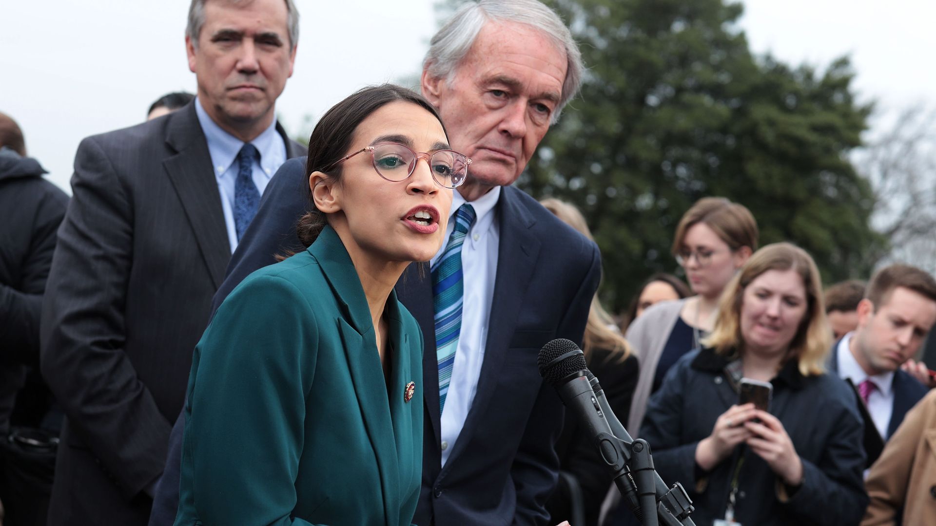U.S. Rep. Alexandria Ocasio-Cortez (D-NY) speaks as Sen. Ed Markey (D-MA) (R) listens during a news conference 