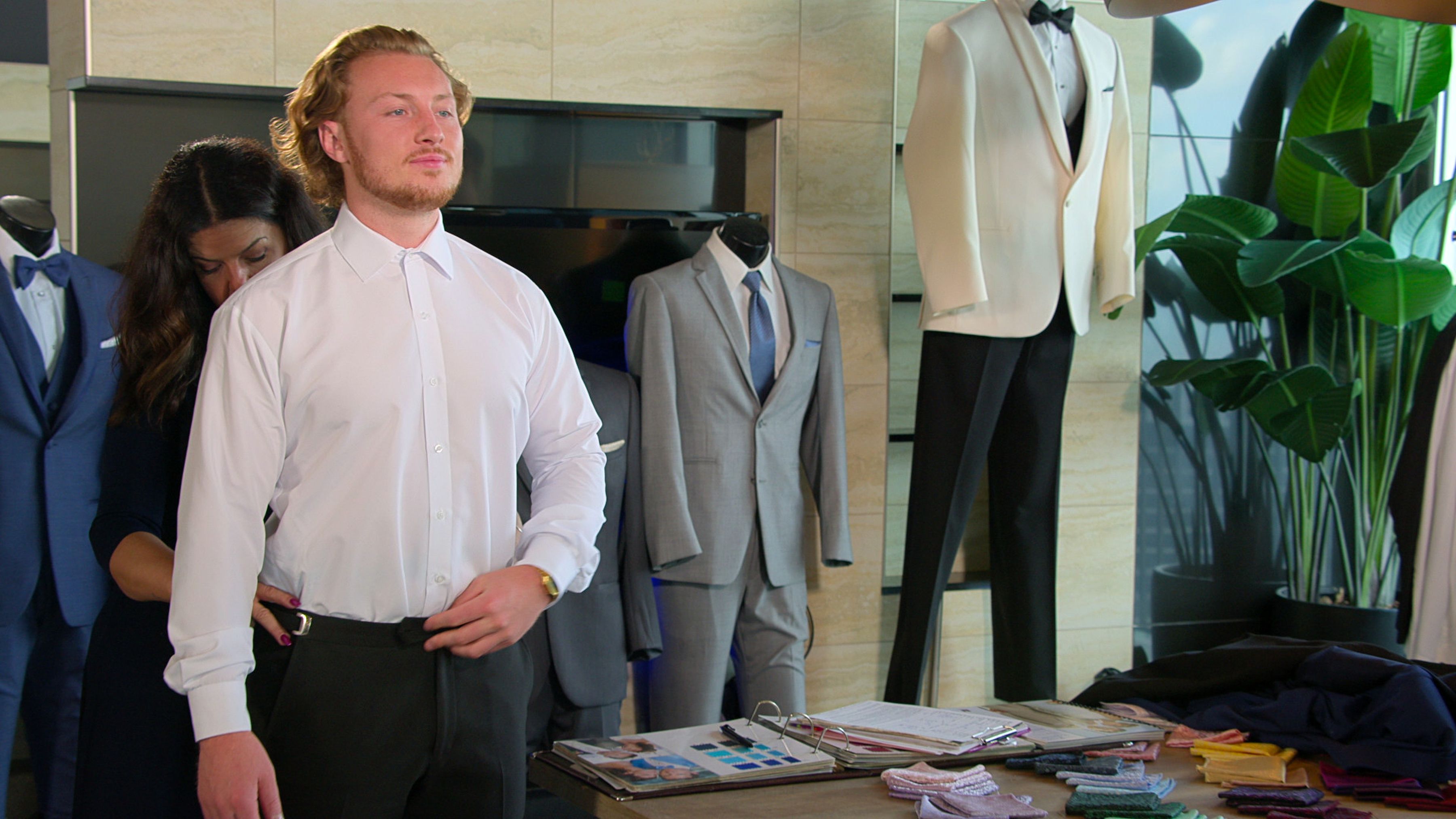 man getting fitted for a suit