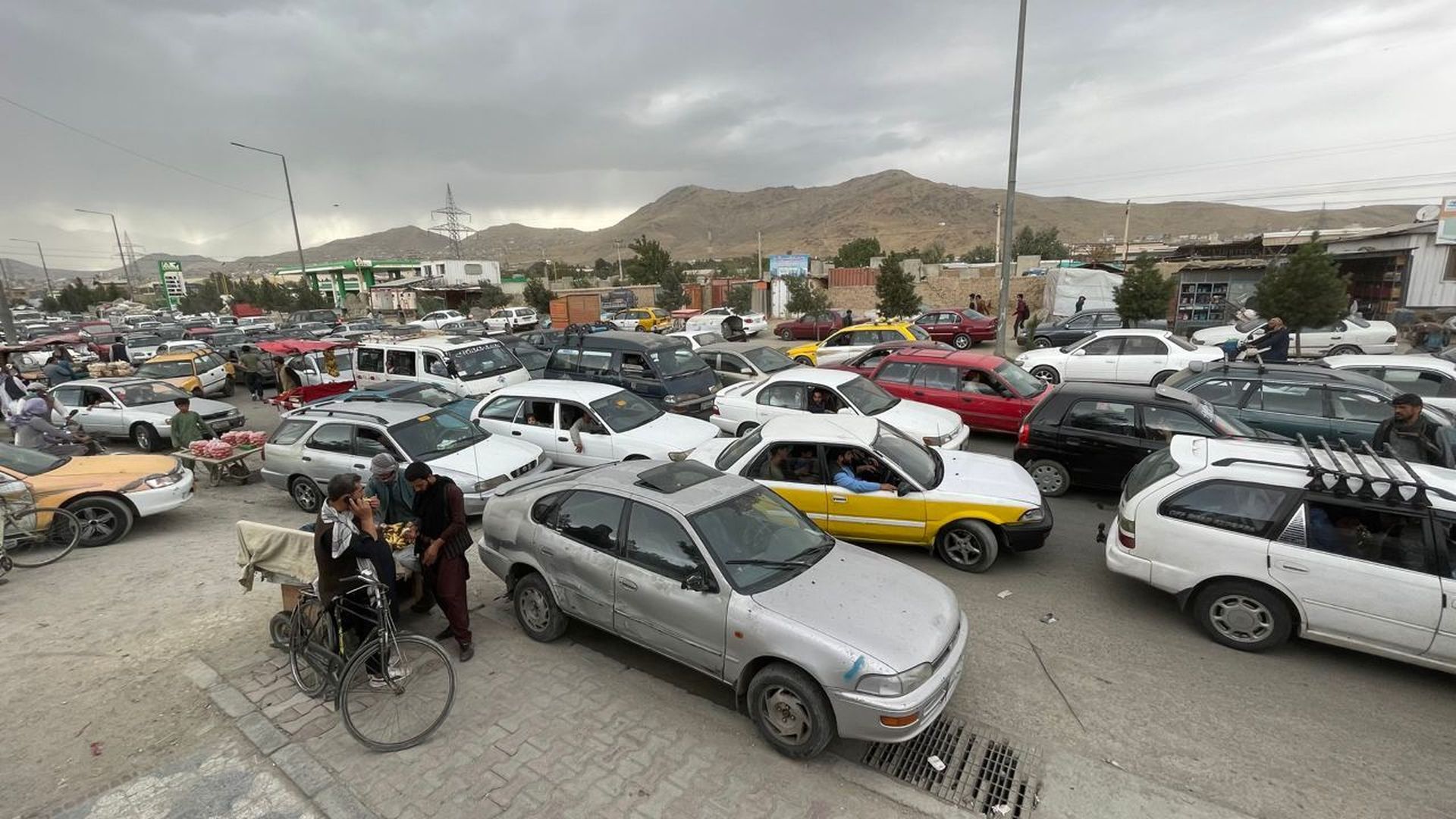 Afghans continue to wait around the Hamid Karzai International Airport as they try to leave the Afghan capital of Kabul, Afghanistan on August 21