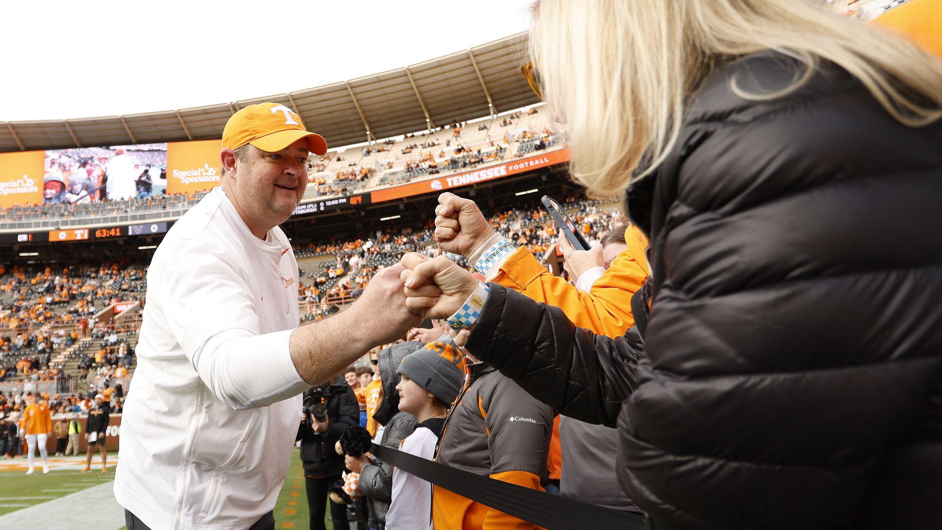 UT coach Josh Heupel fist-bumps a supporter prior to a game last month. 