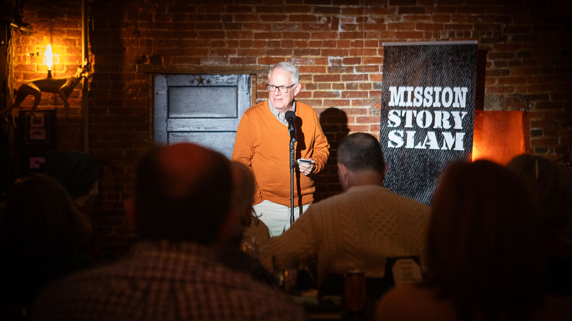 MISSION Story Slam emcee and veteran journalist Chris Satullo on stage at a prior event. 
