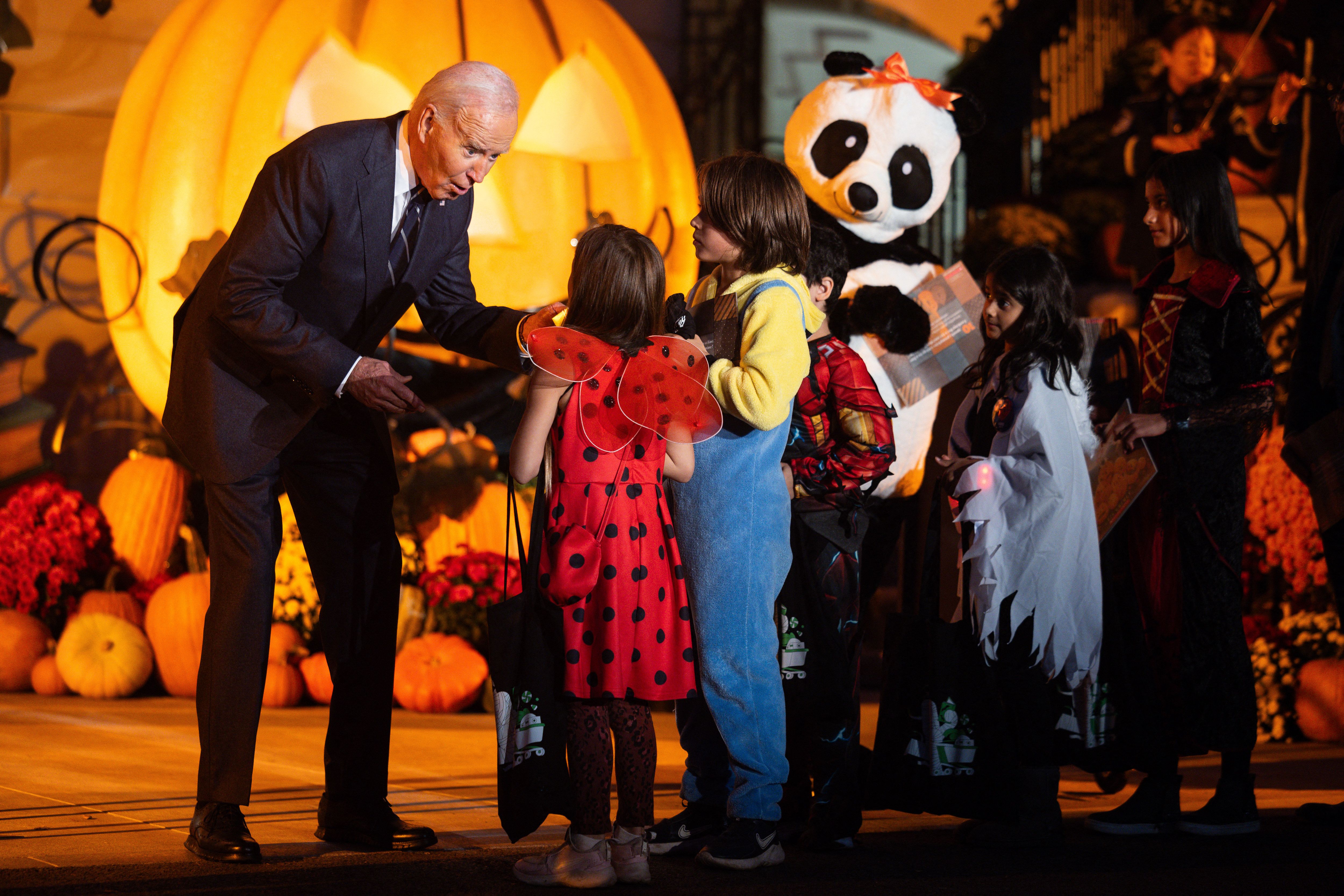 President Biden and First Lady Jill Biden (in the panda costume!) give out candy at a White House trick-or-treat event yesterday.