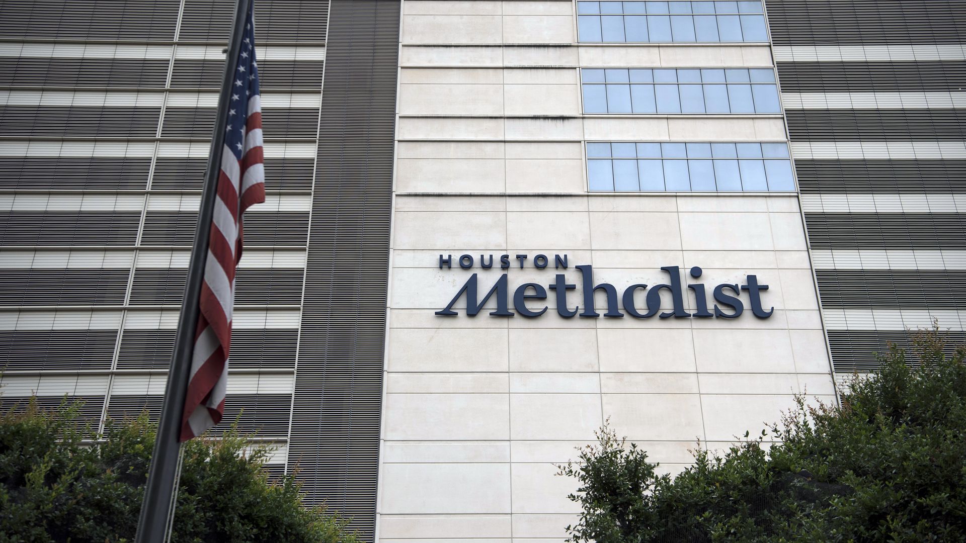 An American flag flies outside the Houston Methodist Hospital at the Texas Medical Center (TMC) campus in Houston, Texas, U.S., on Wednesday, June 24, 2020. 