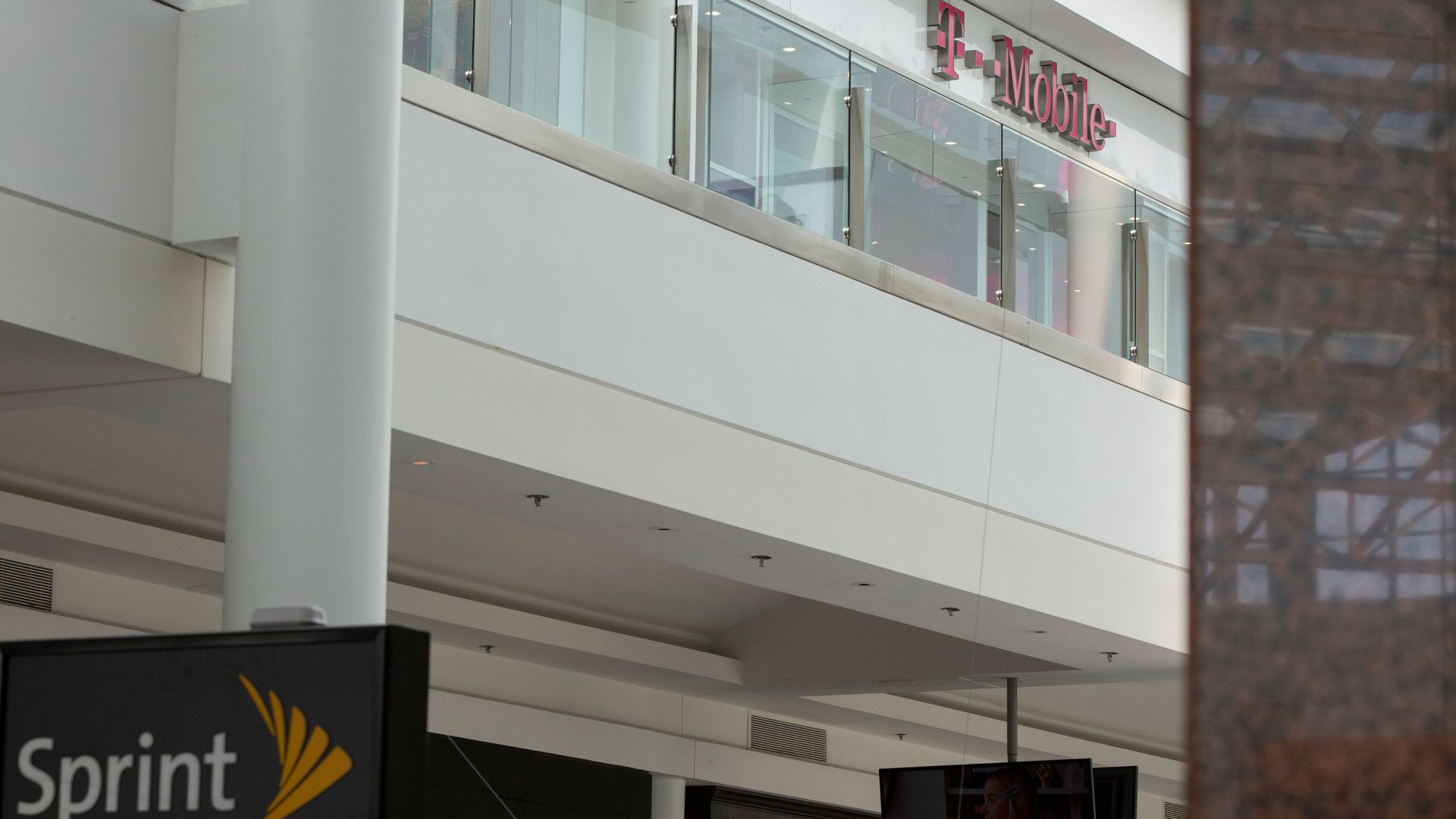 A photo of Sprint and T-Mobile signs on an office complex