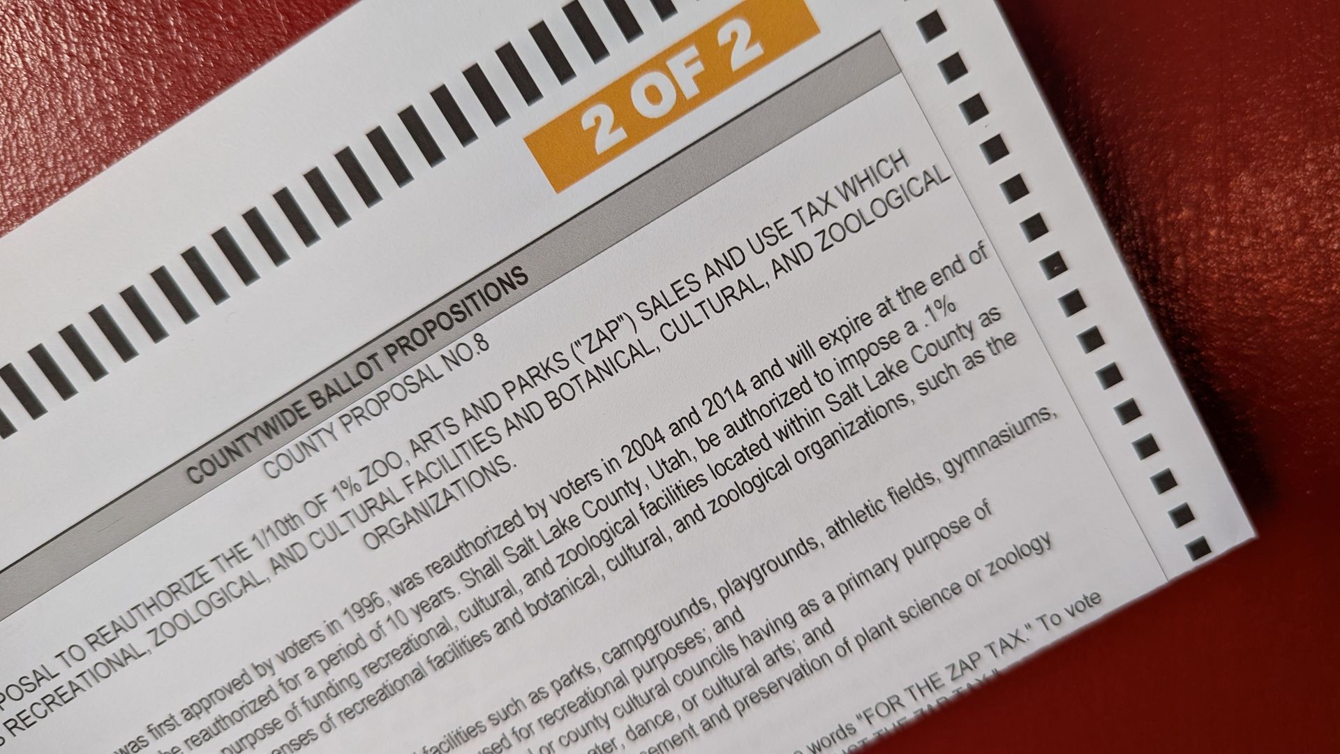 A ballot on a red table.