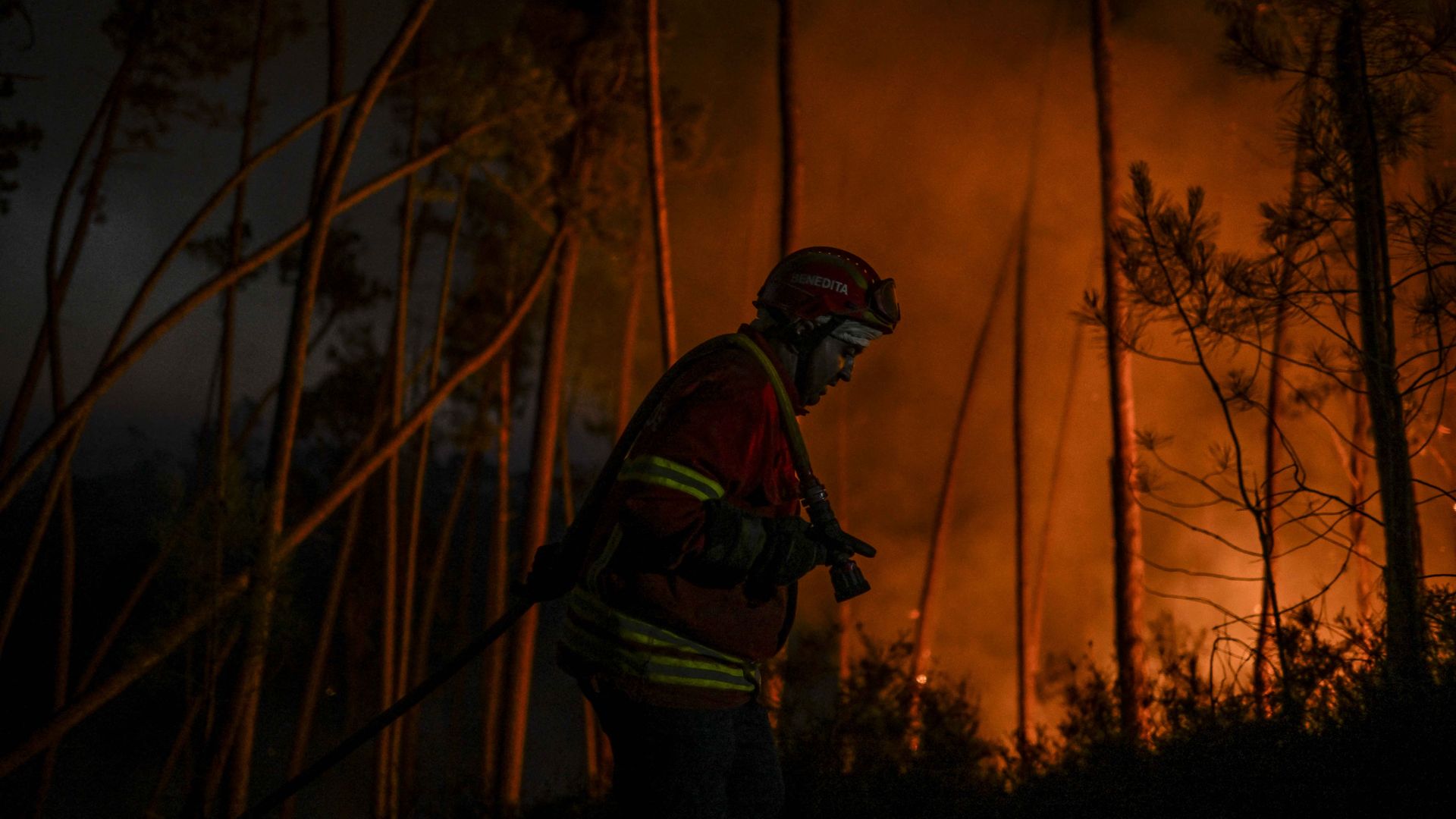 A firefighter works to extinguish a wildfire at Casais do Vento in Alvaiazere on July 10, 2022.