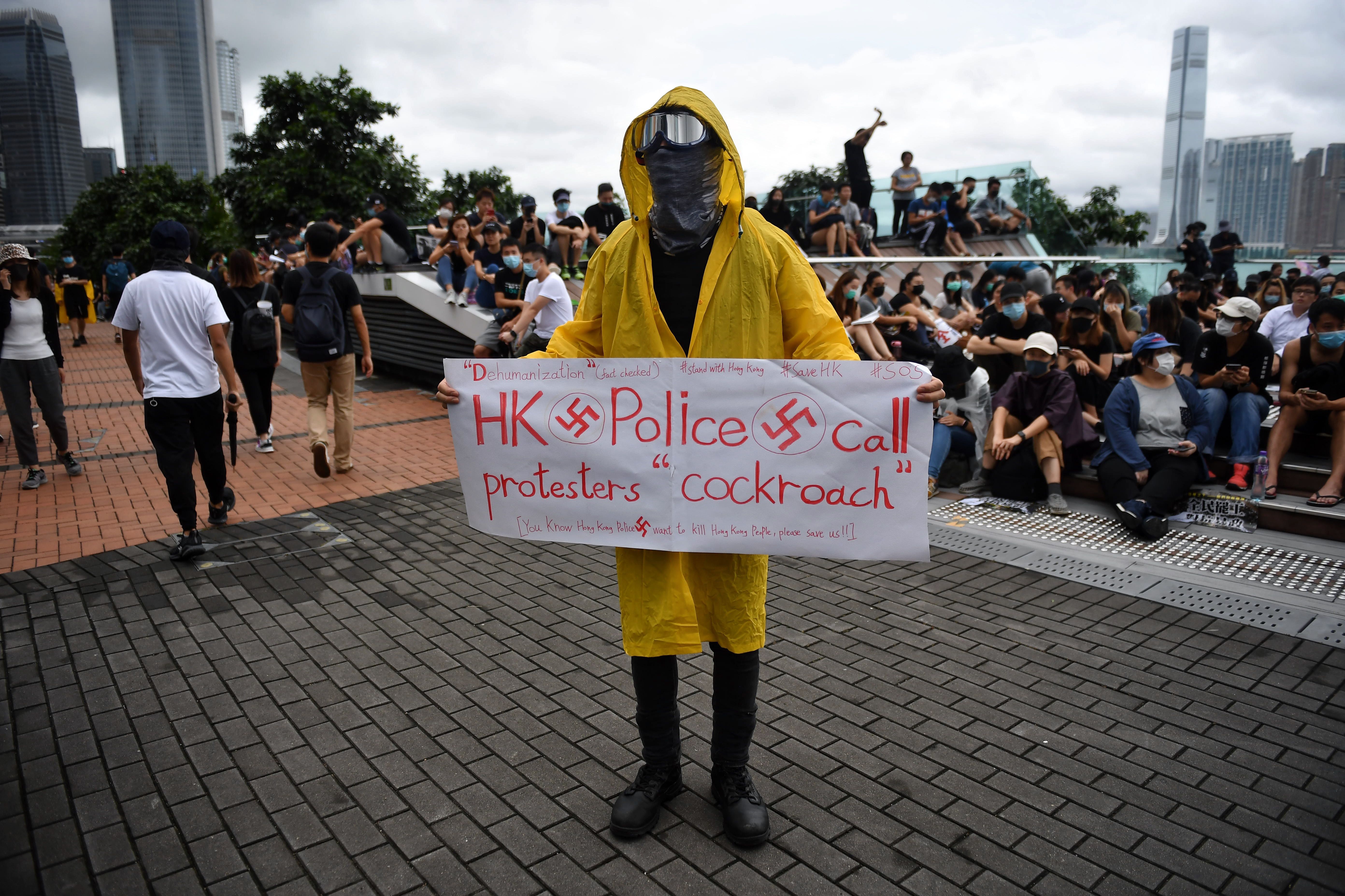 A protester holds a sign during a rally at Tamar Park in Hong Kong on September 2