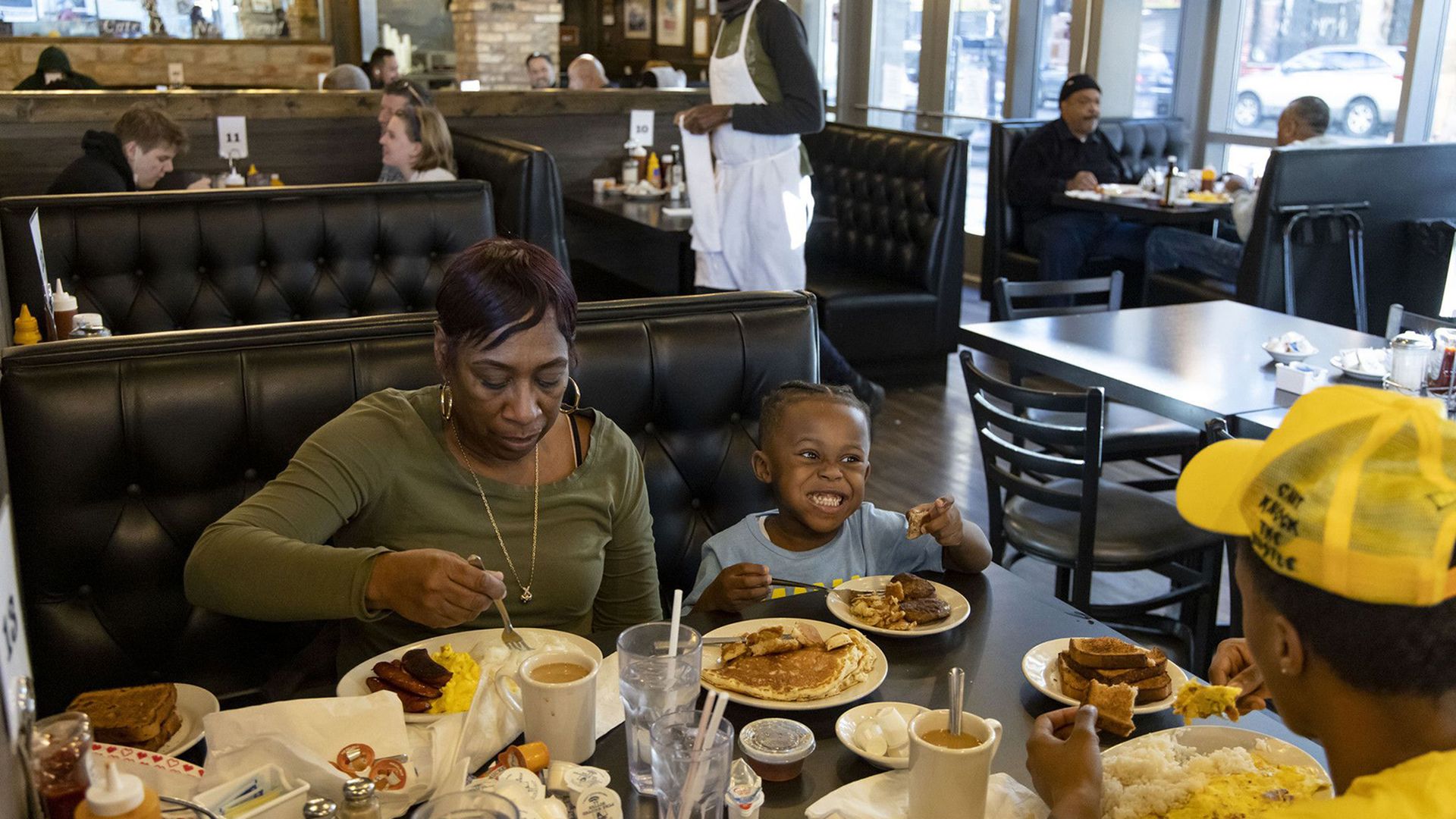 Photo of a family eating at a restaurant. 