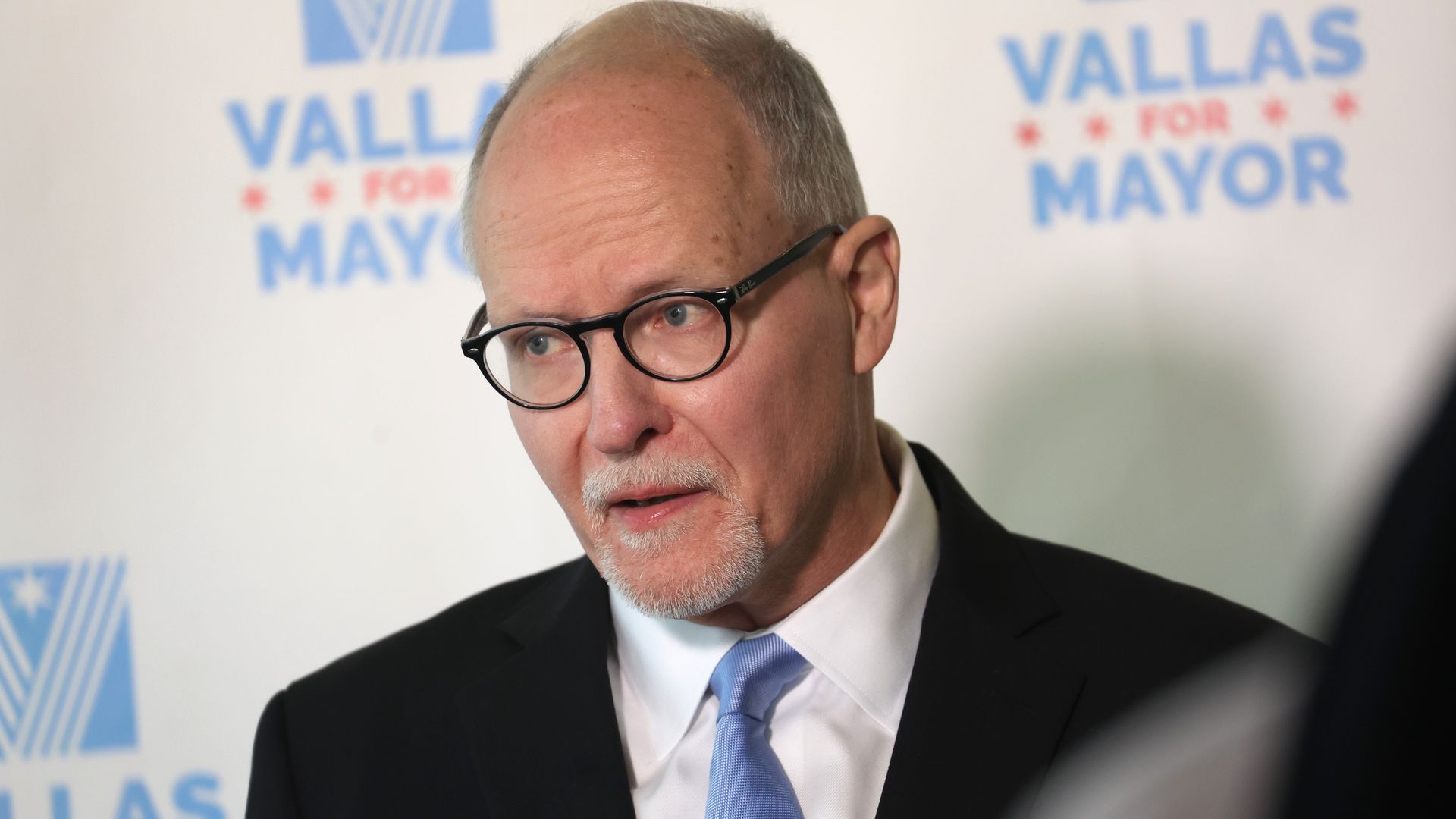 Photo of a man talking at a press conference