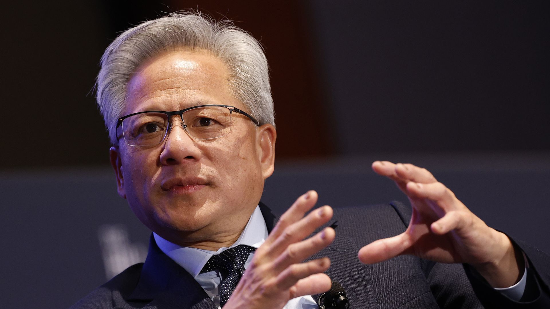 Nvidia CEO Jensen Huang makes a hand gesture while talking.
