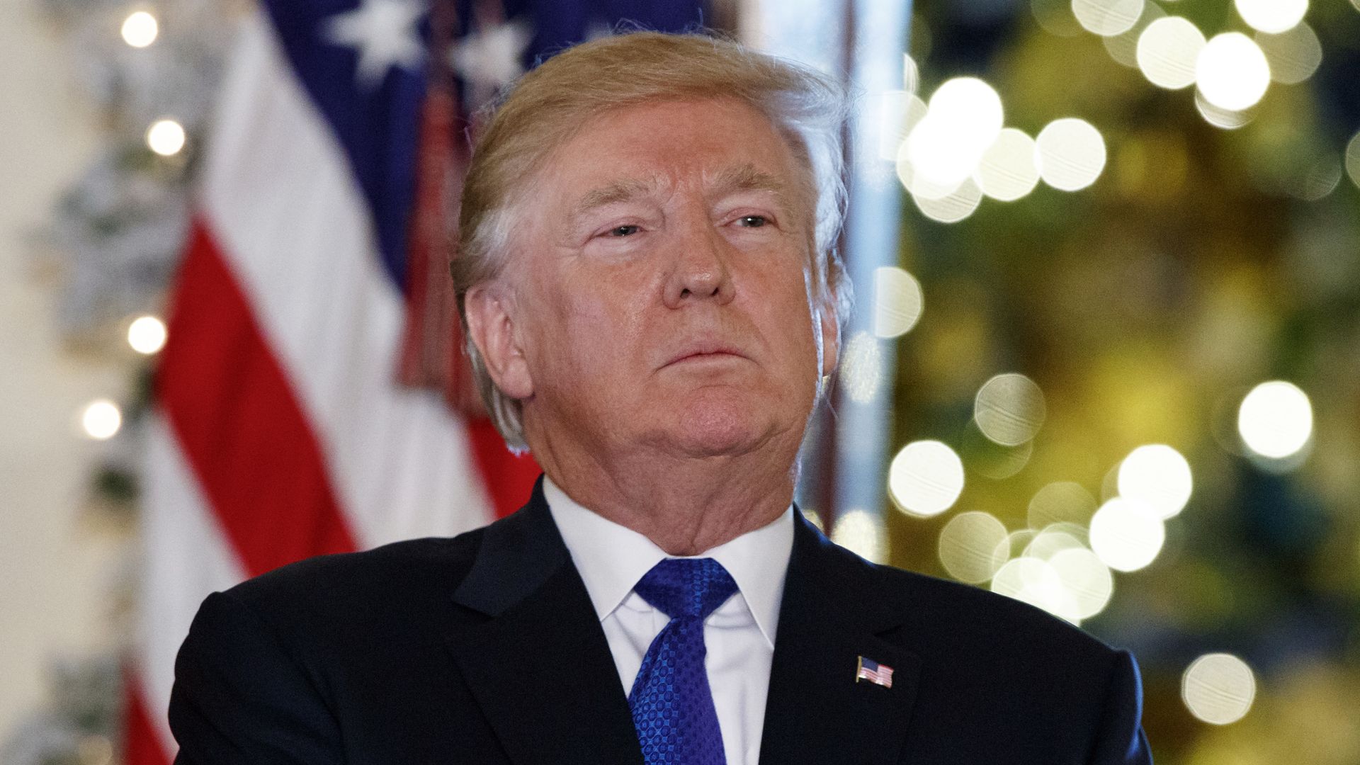 Donald Trump purses his lips with his chin up.