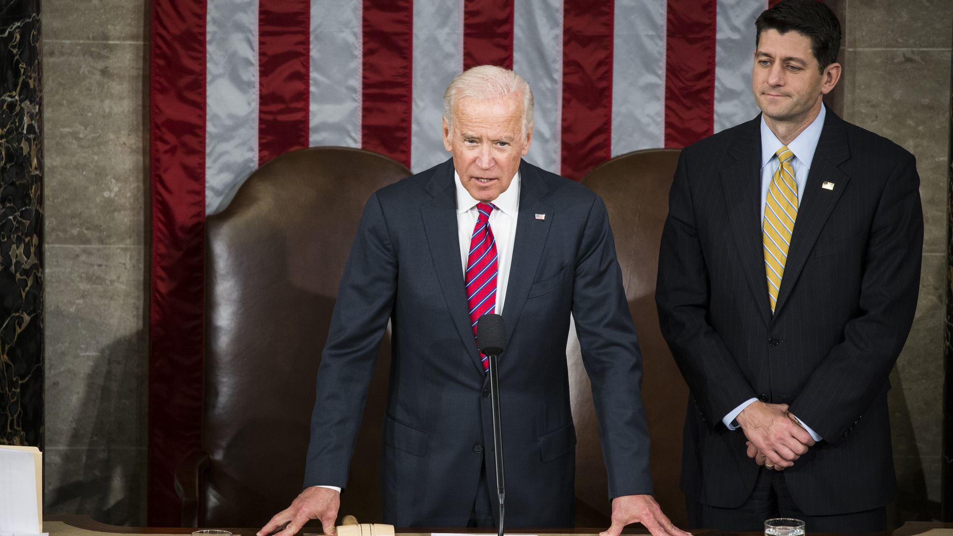 In this image, Biden speaks in the House while Paul Ryan stands next to him.