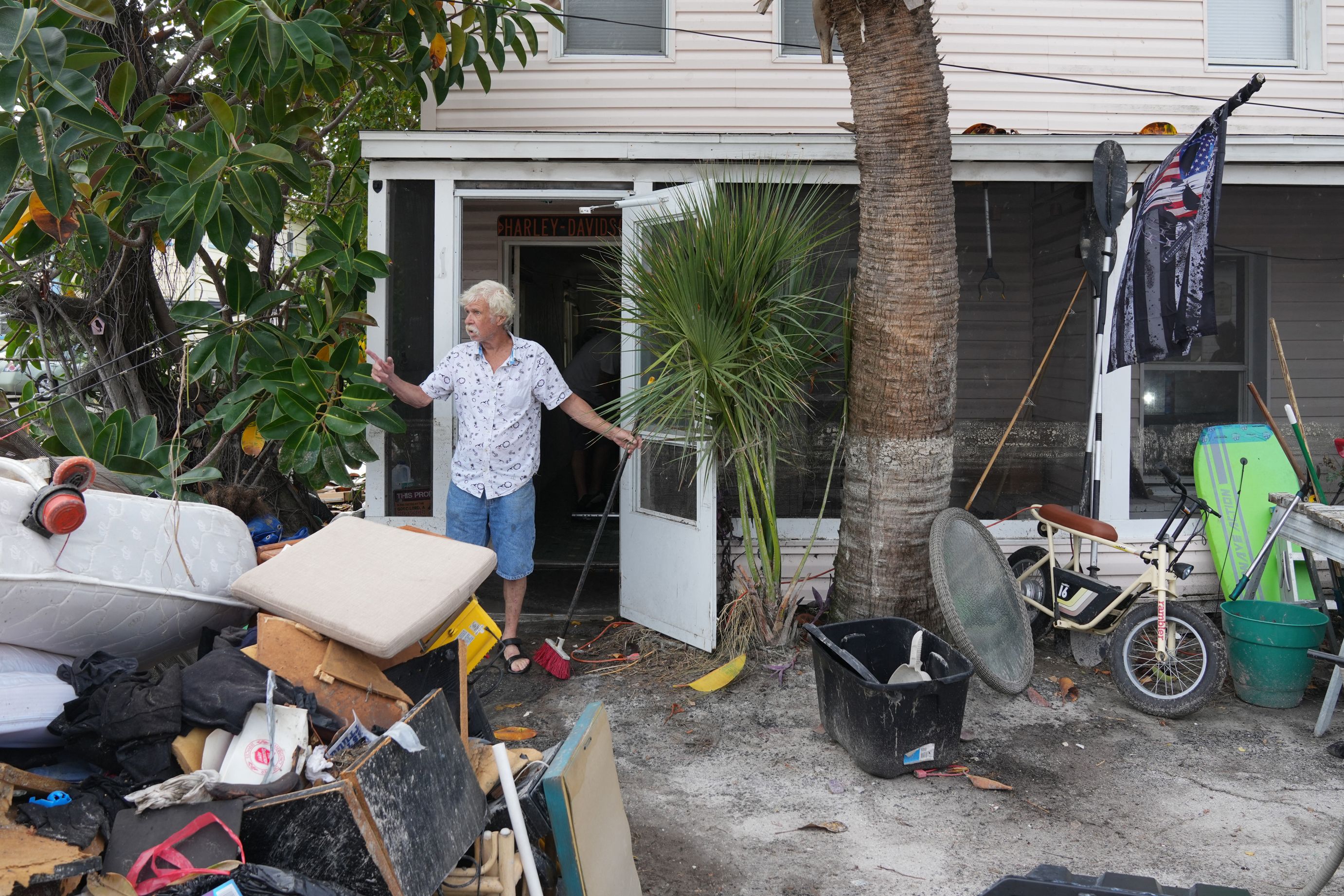 A man clears debris left by Hurricane Helene from his home ahead of Hurricane Milton's expected landfall in the middle of this week in Treasure Island, Florida on October 7, 2024.