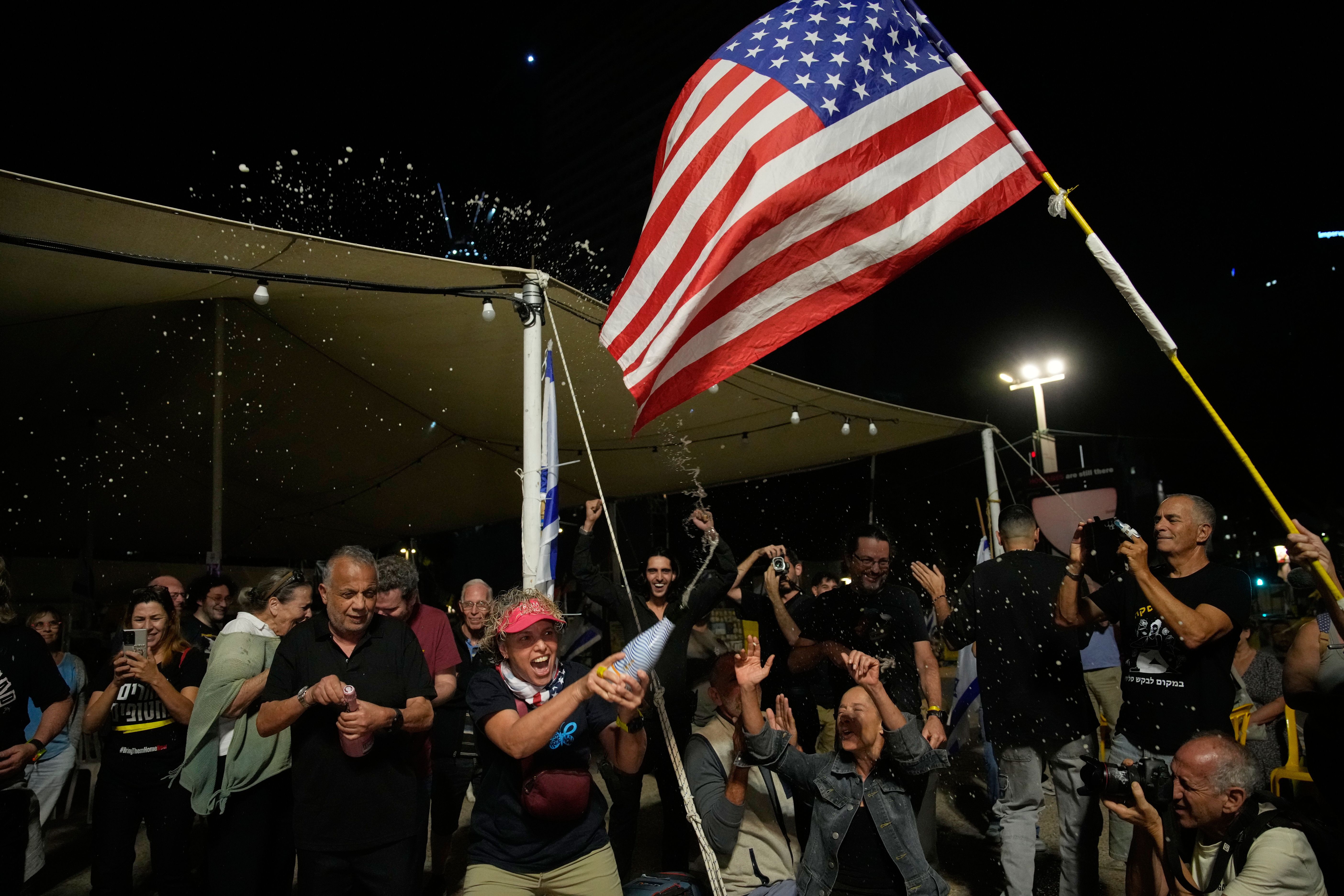 Relatives and supporters of Israeli hostages celebrate yesterday at a plaza in Tel Aviv known Hostages Square.