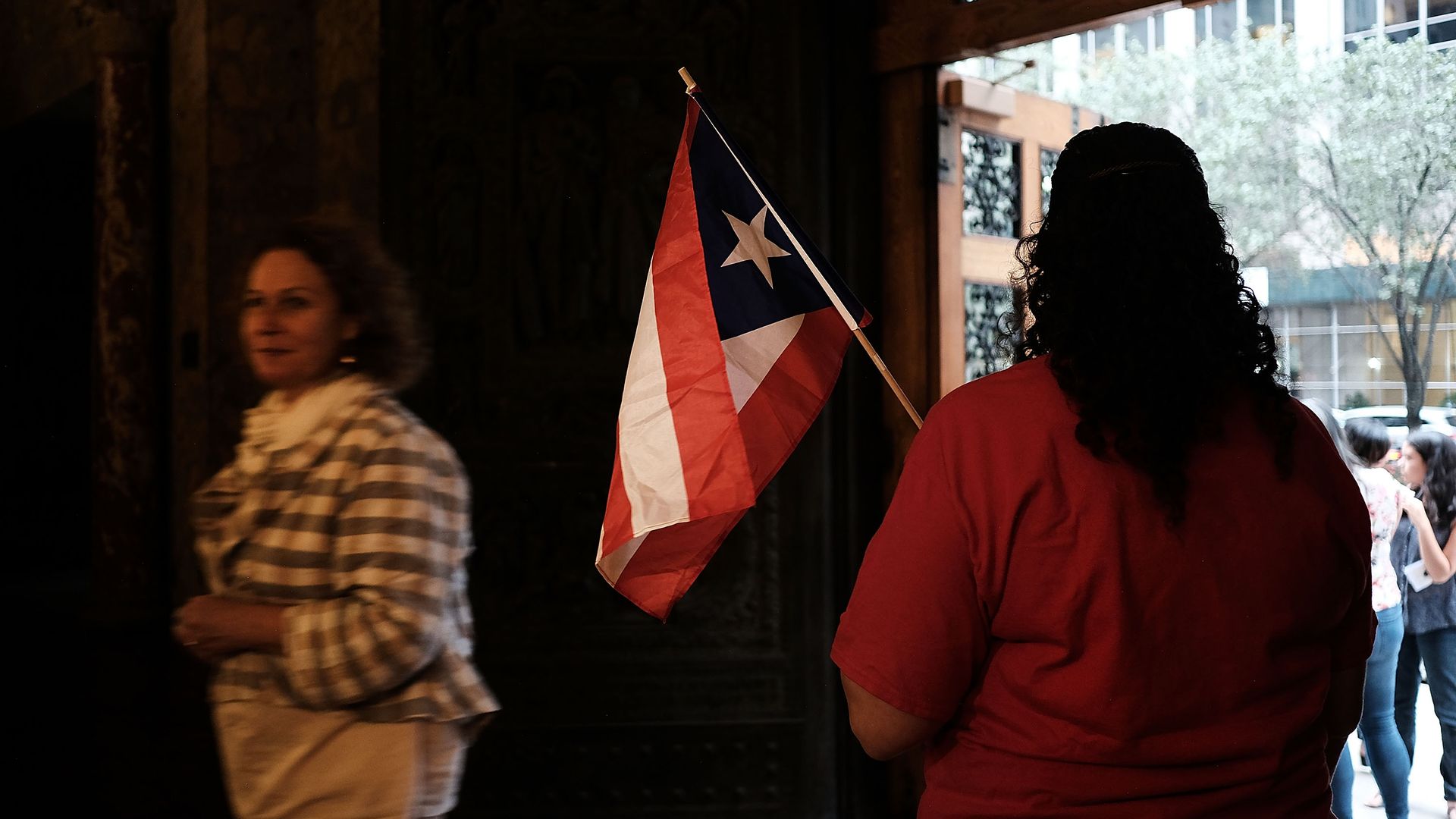 A person holds a Puerto Rican flag.