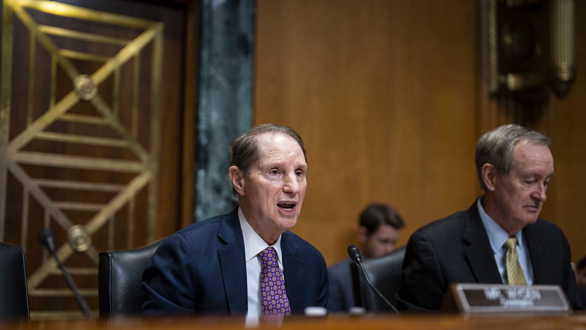 Senator Ron Wyden, a Democrat from Oregon and chairman of the Senate Finance Committee, speaks beside Senator Mike Crapo, a Republican from Idaho and ranking member of the Senate Finance Committee, during a hearing in Washington, DC, in April 2023