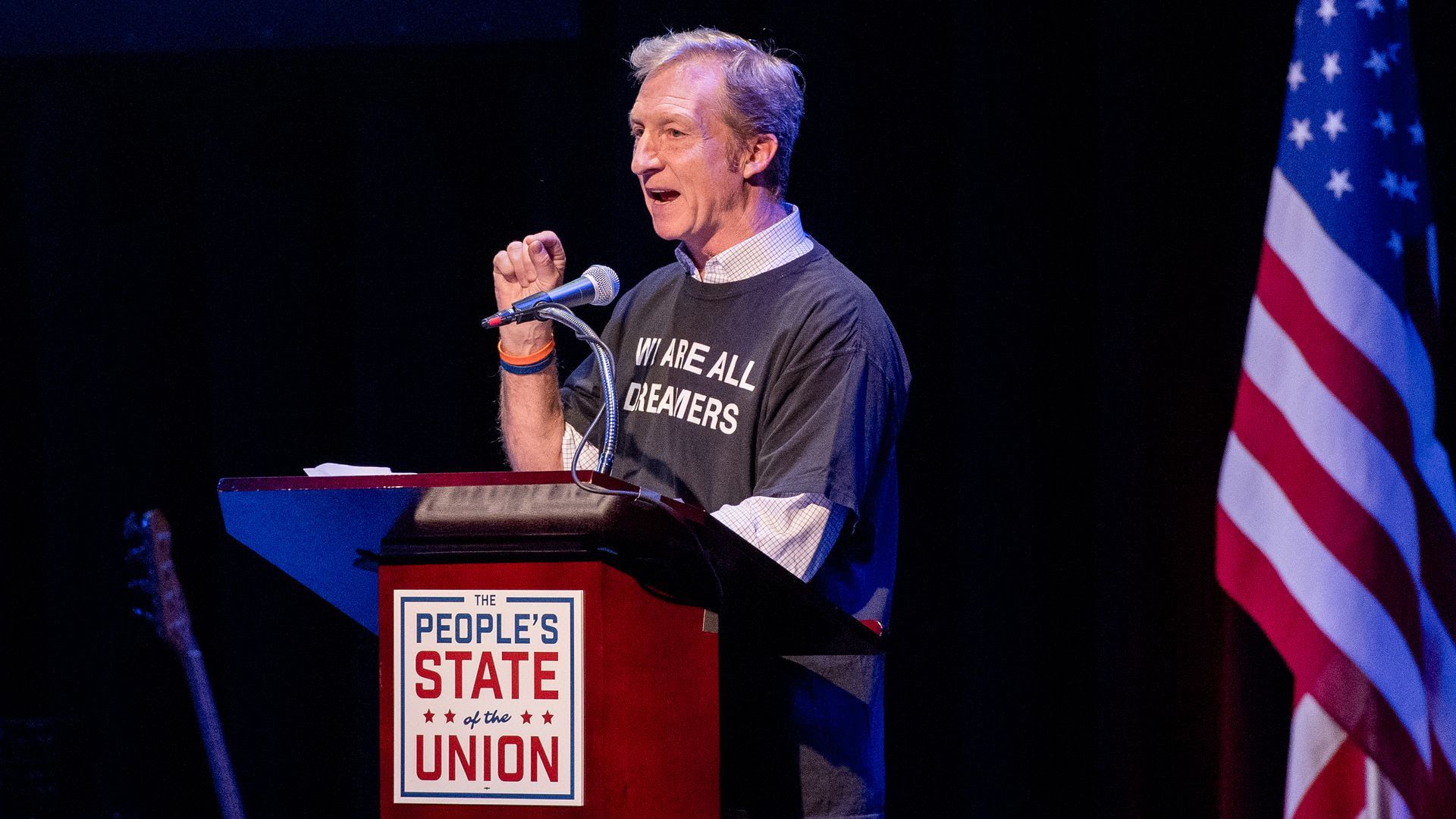 Tom Steyer speaking at a podium