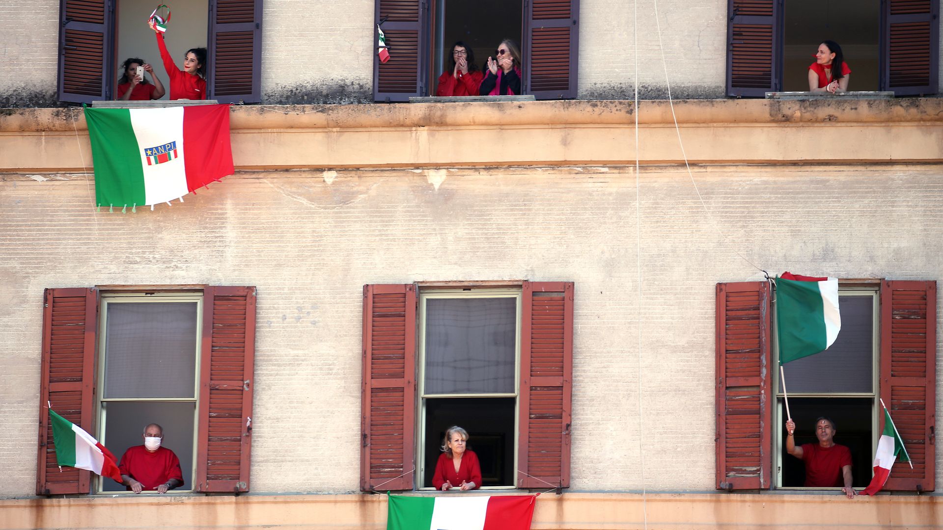 People draping Italian flags outside their windows
