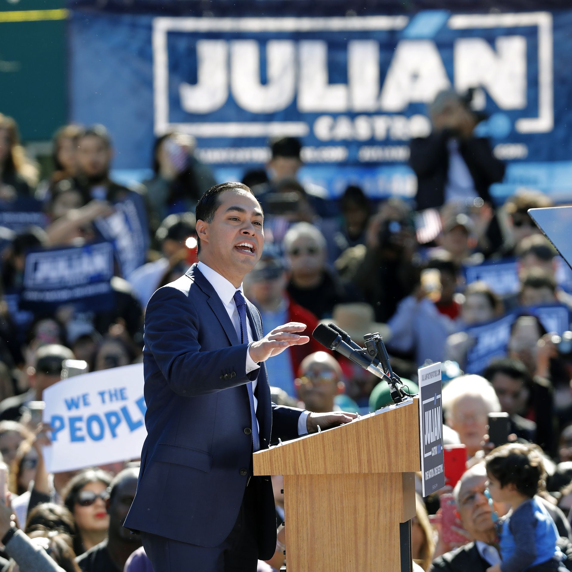 Julián Castro speaks from behind a podium at a campaign event