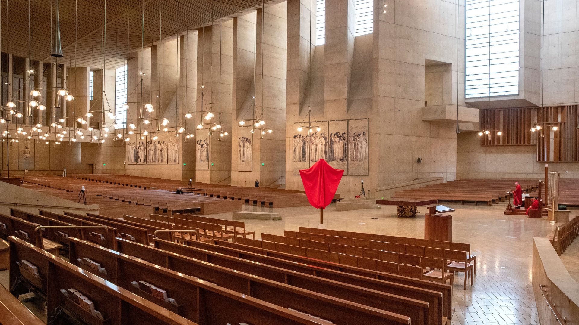 In this image, rows of pews are shown in a church