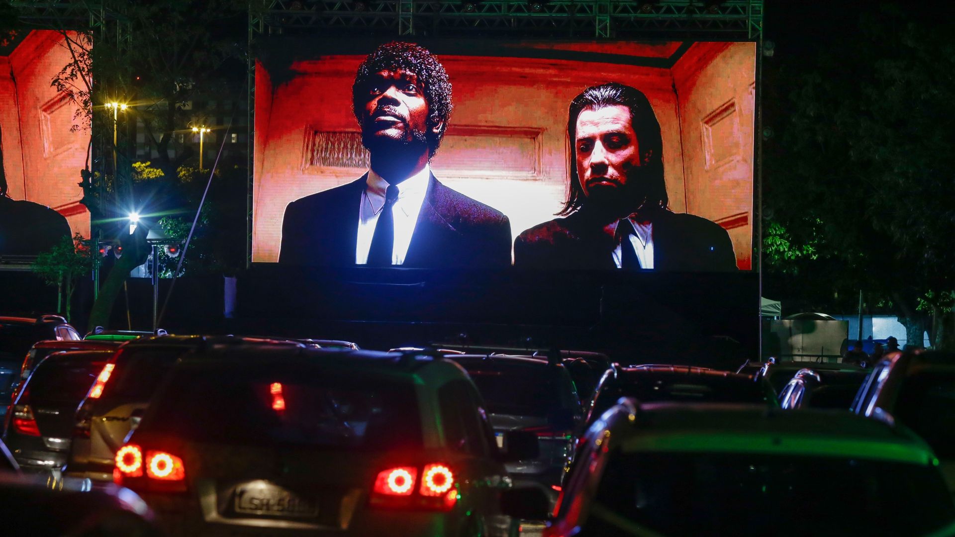 A drive-in movie theater showing a scene from "Pulp Fiction" featuring Samuel L. Jackson and John Travolta. 