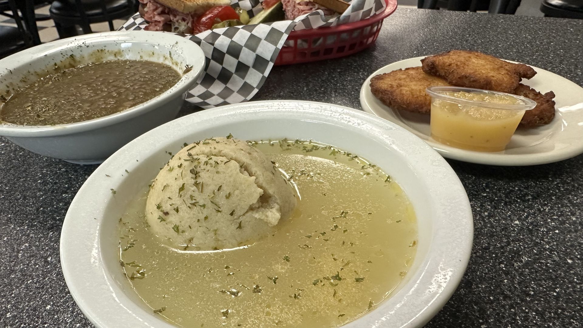 Photo shows a bowl of matzo soup.