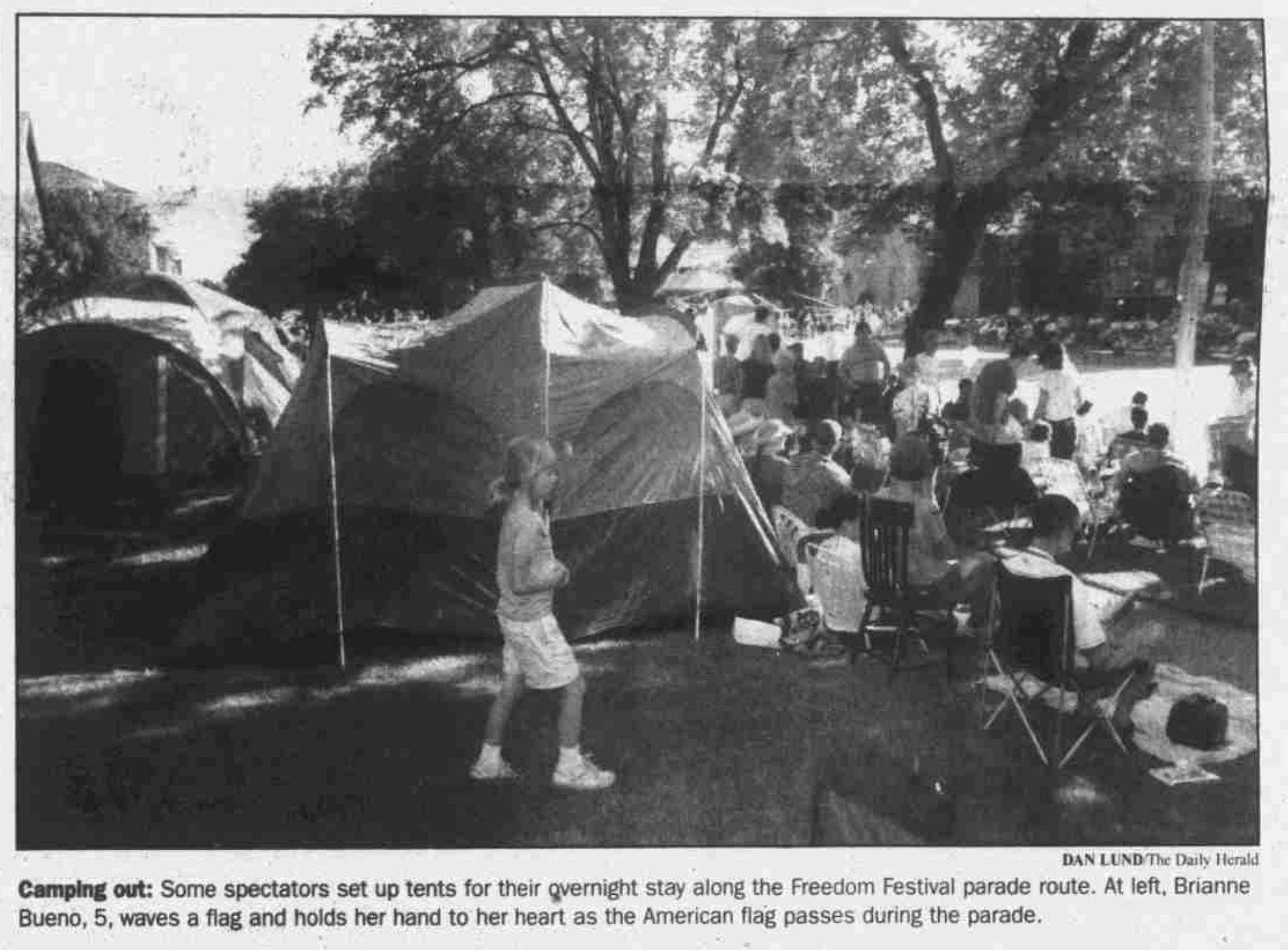 A newspaper photo of tents along a parade route.