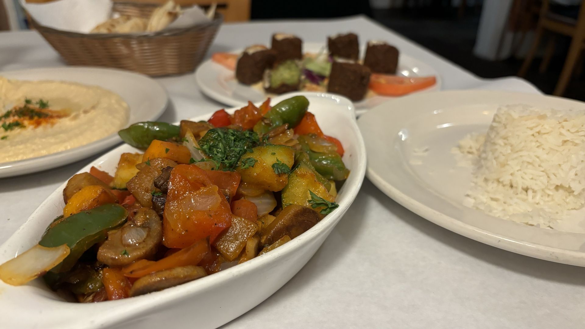Vegetable stew in a dish on a table with rice