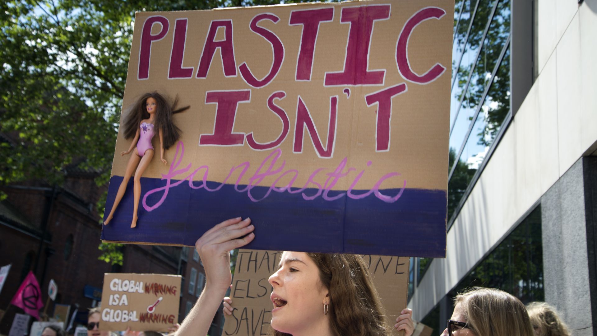 School Climate Strike, London, England, UK. A girl holds a sign with a Barbie doll which says 'Plastic is not fantastic'.