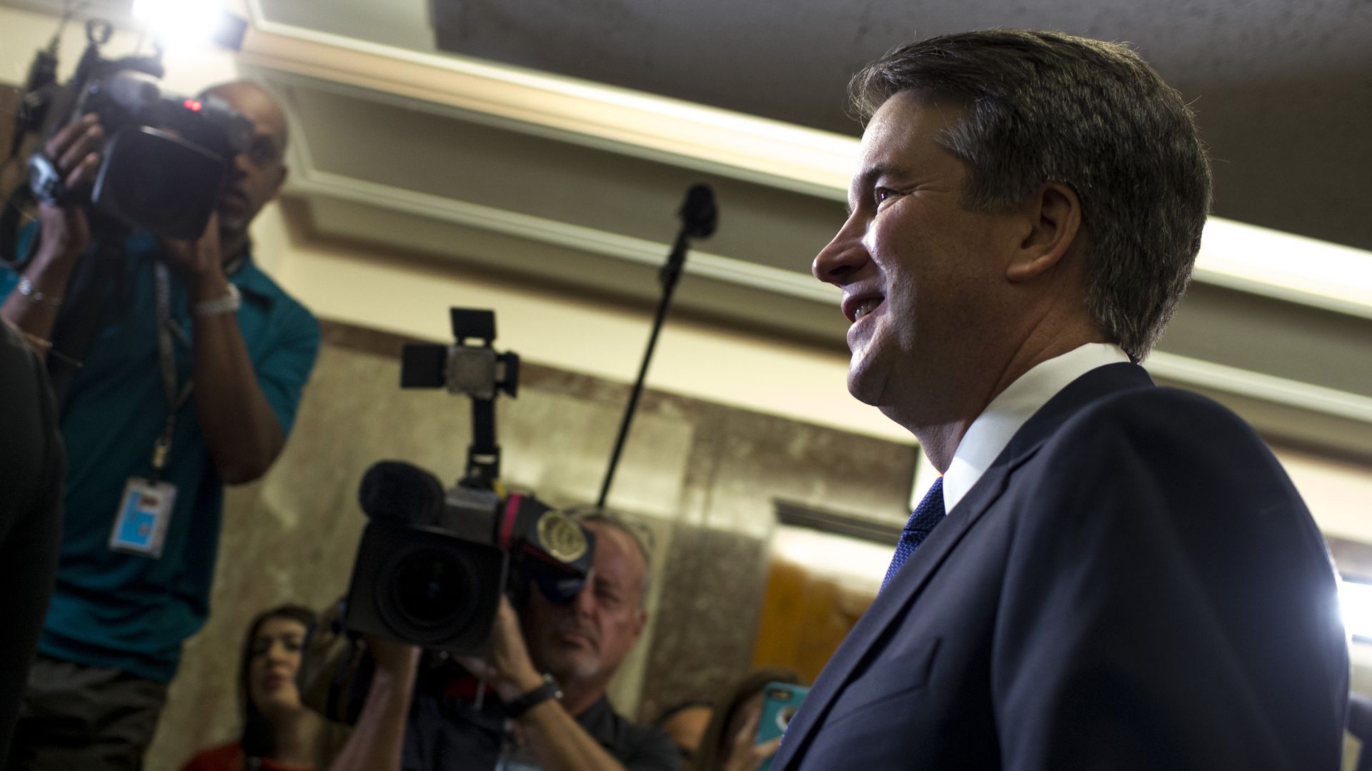 Brett Kavanaugh surrounded by media.