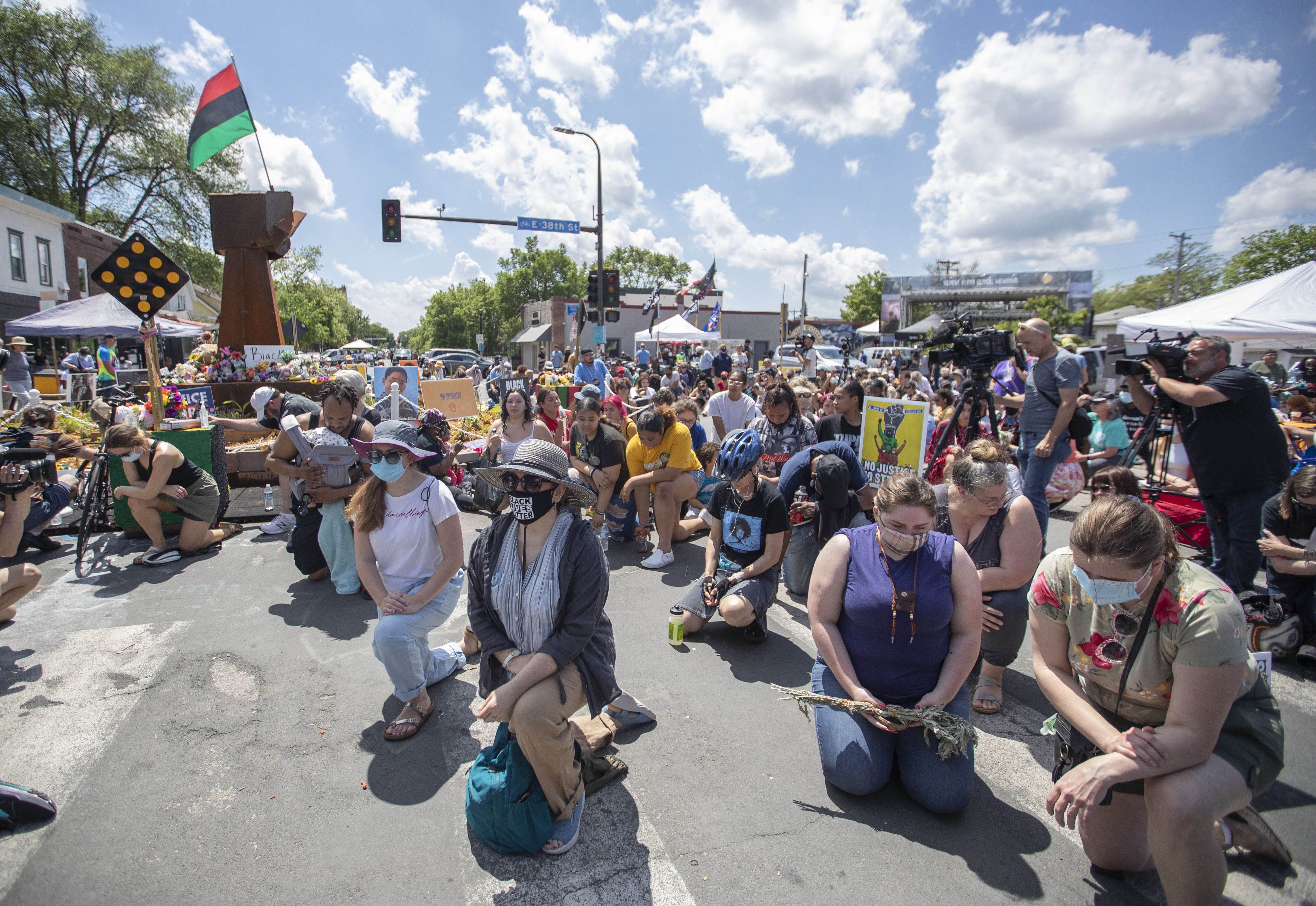 Community members at George Floyd Square kneel to mark the first anniversary of his death in Minneapolis, Minnesota, on May 25. 