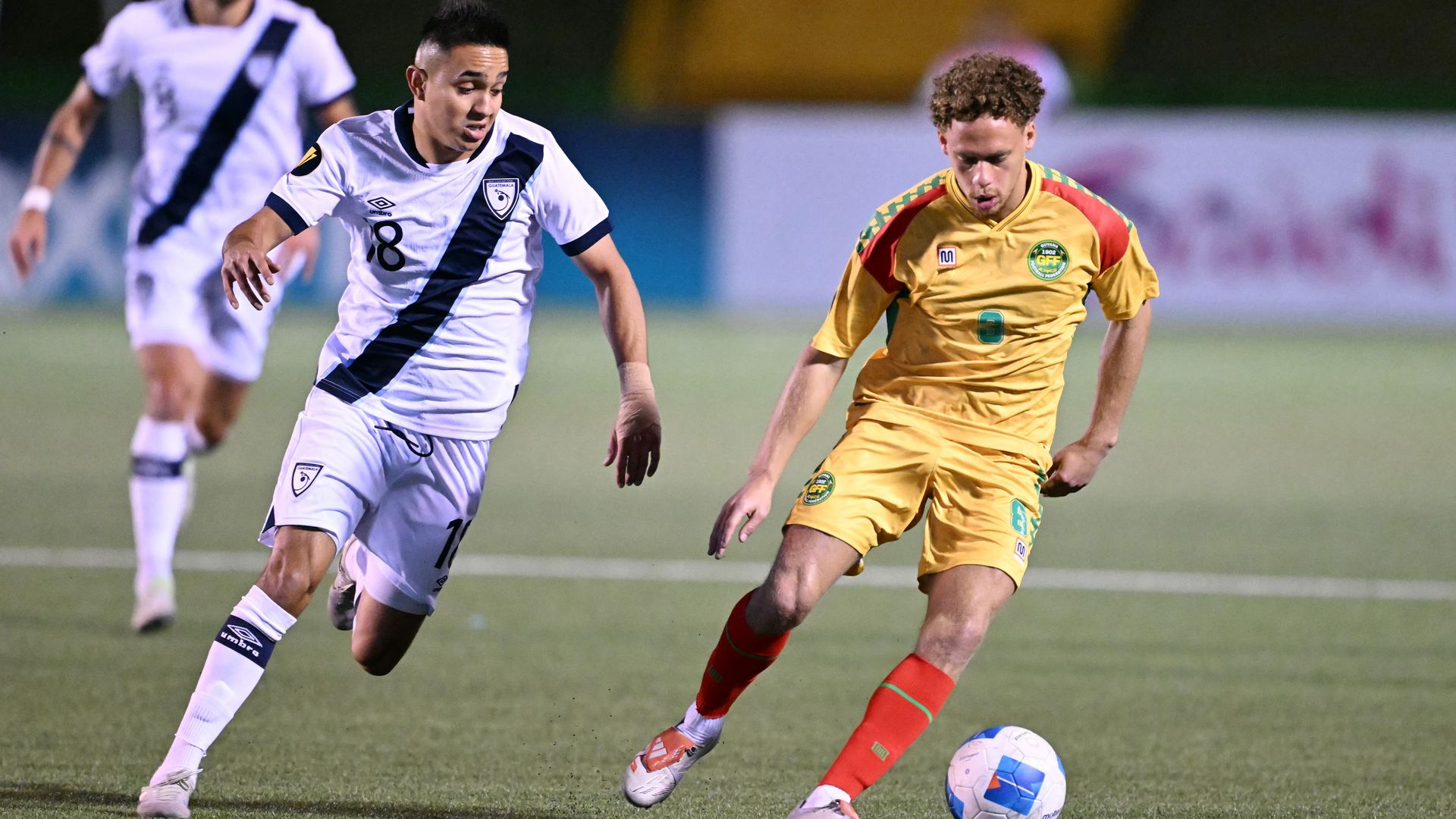Photo of two soccer players fighting for a ball. 