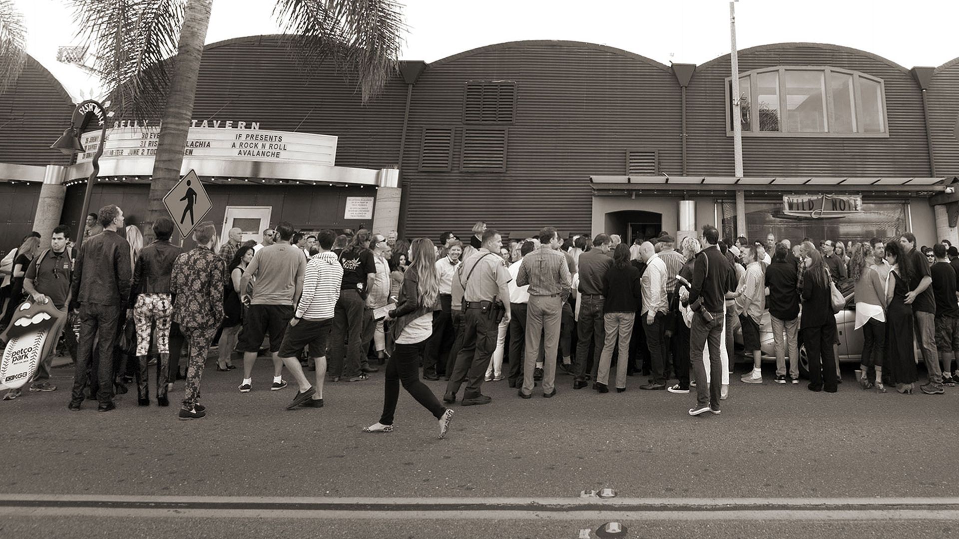 Fans wait outside a music venue to see The Rolling Stones.