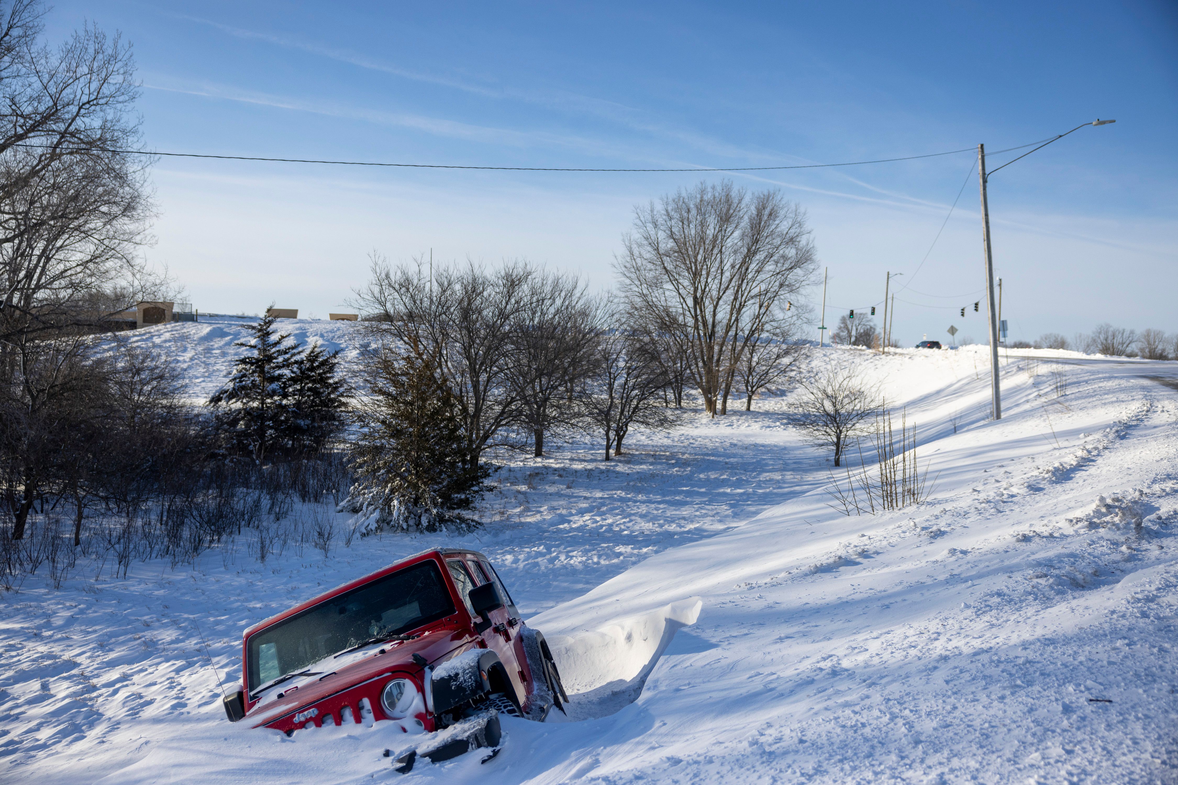 A vehicle off an embankment during a winter storm ahead of the Iowa caucus in West Des Moines, Iowa, US, on Sunday, Jan. 14, 2024. Iowans on Monday will cast the first votes in the 2024 presidential nominating process during a caucus that's likely to show depressed turnout because of historically frigid weather. P