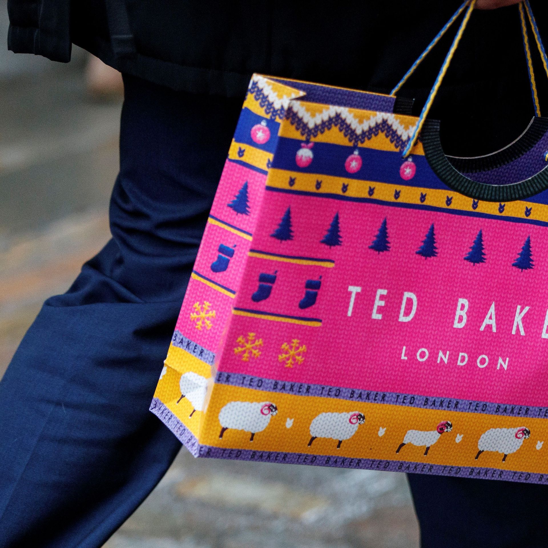 A customer carries a Ted Baker-branded shopping bag after leaving a store in London. Photo: Tolga Akmen/AFP via Getty Images